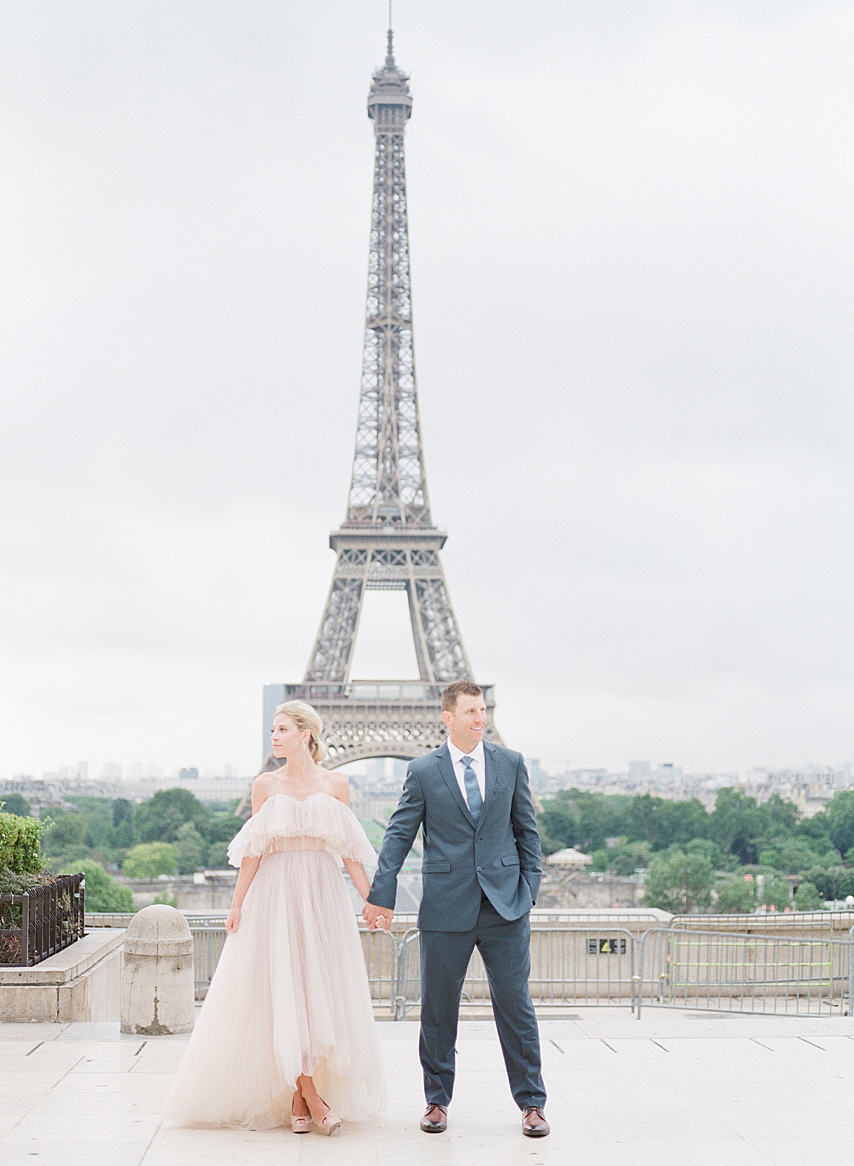 Eiffel Tower Wedding Bride and Groom Holding Hands Looking off Photo