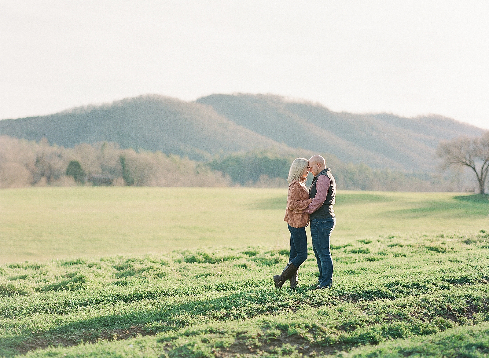 Couple Hugging Nose To Nose With Mountain Background Photo