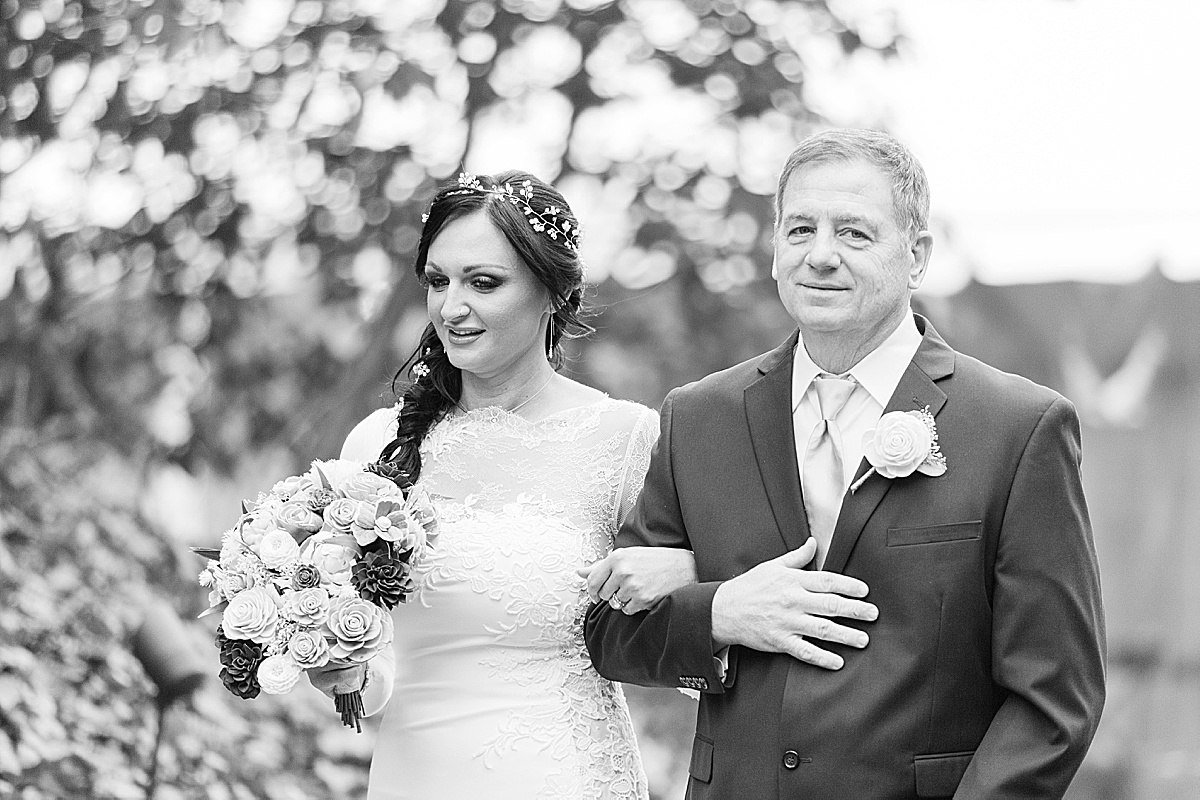 Black and White of Bride and Father Walking Down Aisle Photo