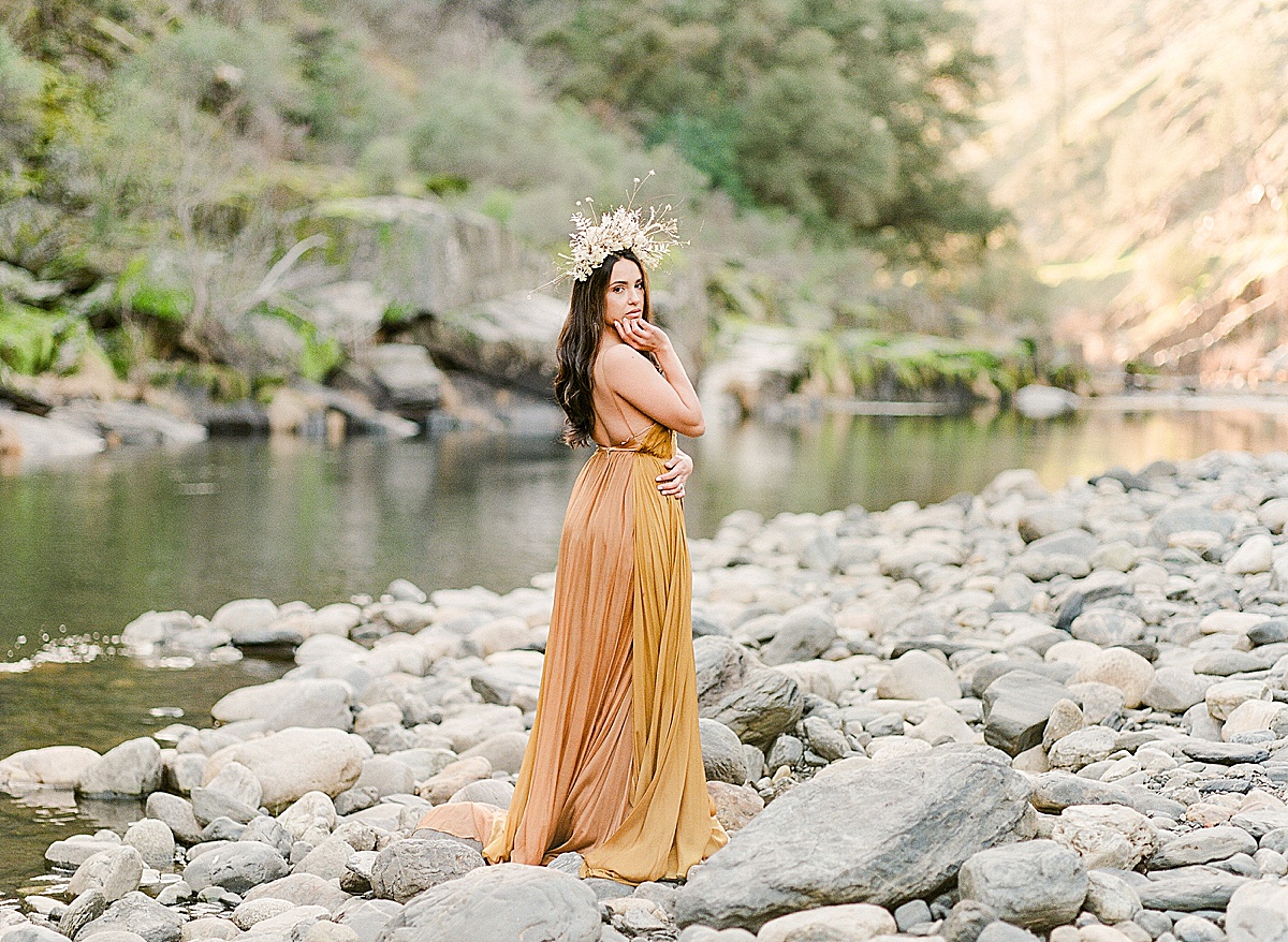 Leanne Marshall Golden Gown Model Looking Over Her Shoulder On Merced River Photo