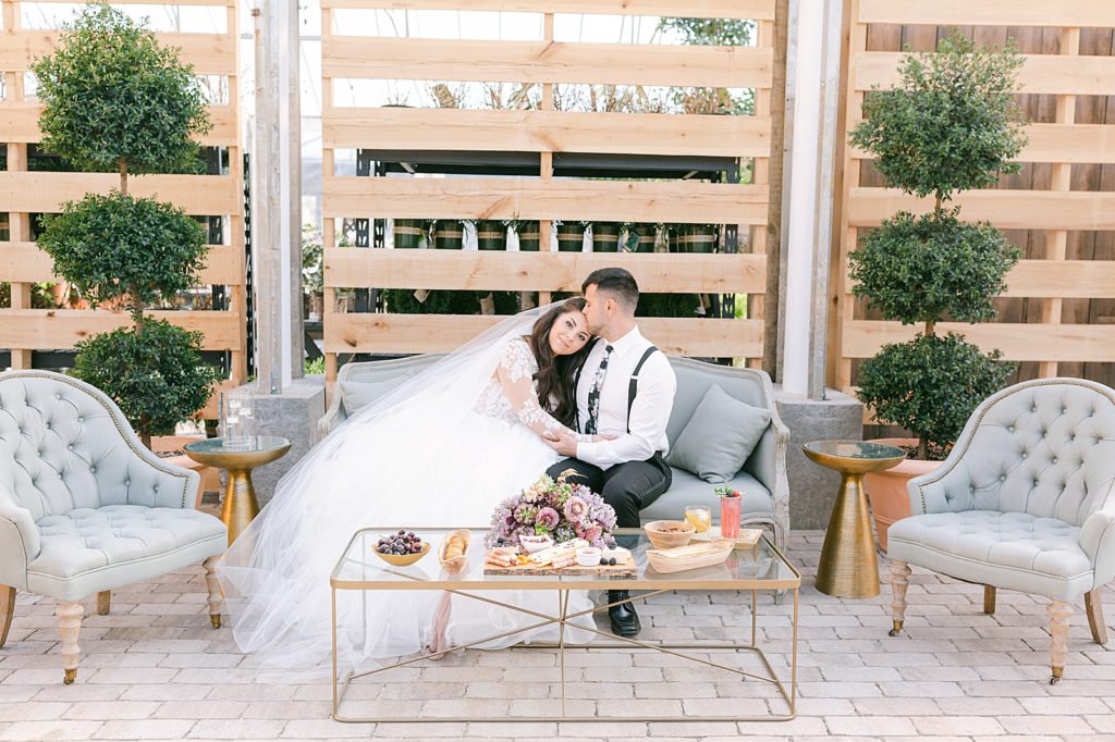 Wedding Planning Guide Bride and Groom Snuggling on Couch at their wedding venue Photo 