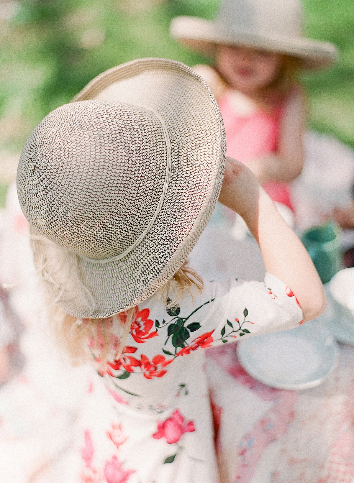 Back of Little Girl In a Sunhat drinking tea Photo 