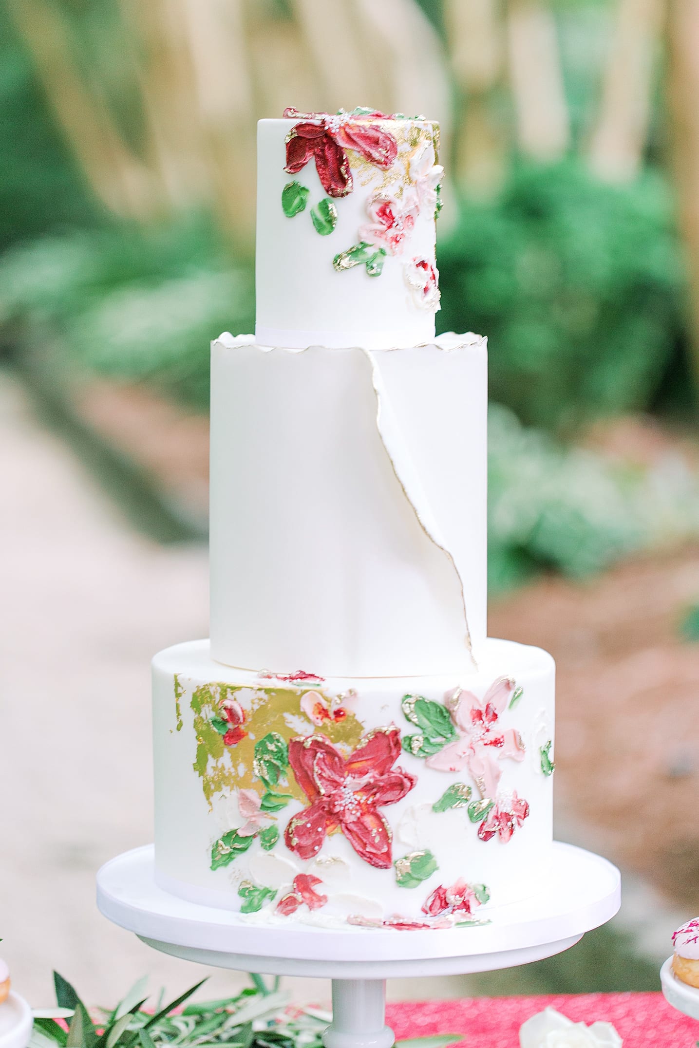 White Wedding Cake with Ruffle and Red and Pink Flowers Photo 