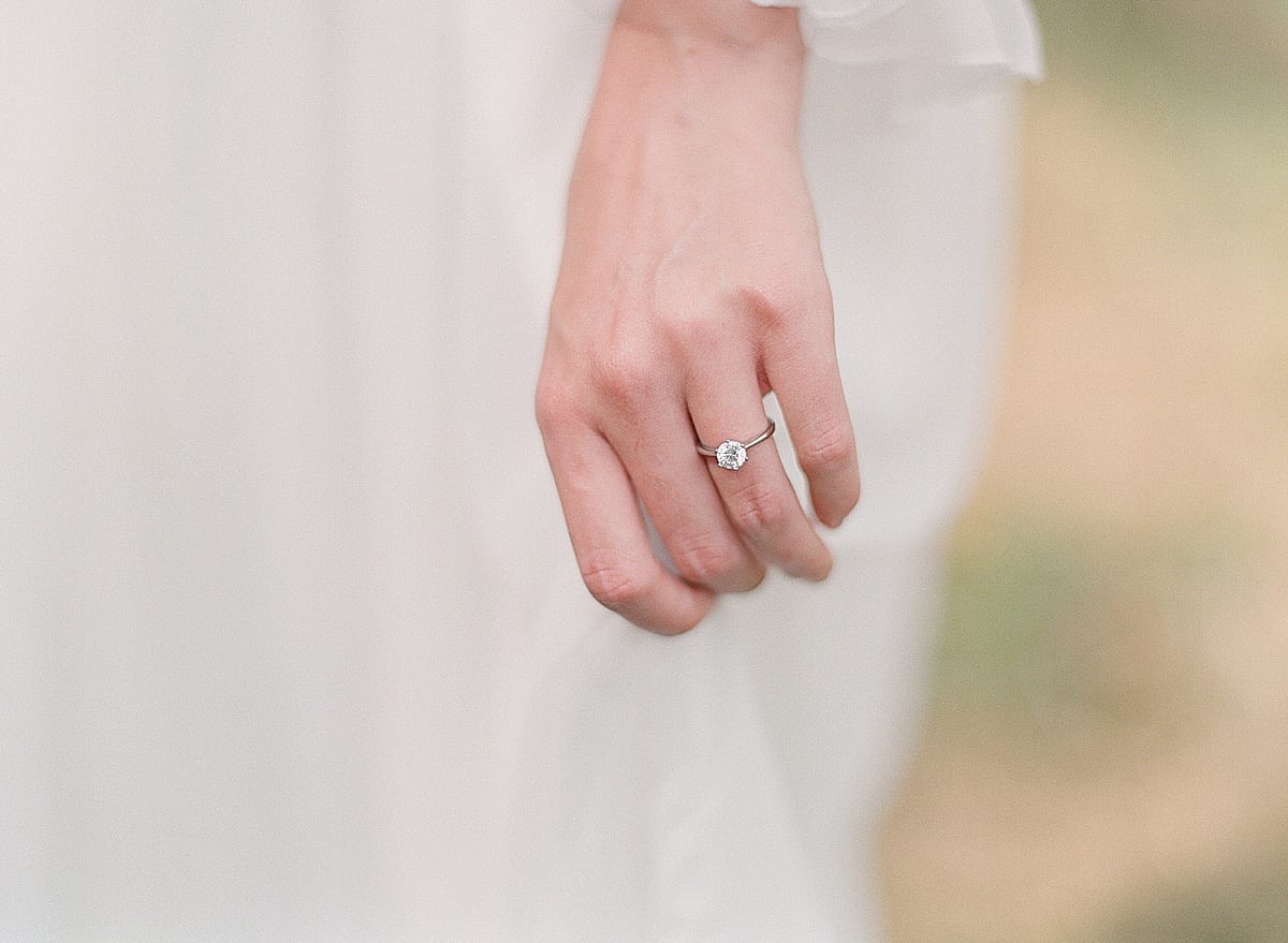 Detail of Brides Hand holding wedding Dress