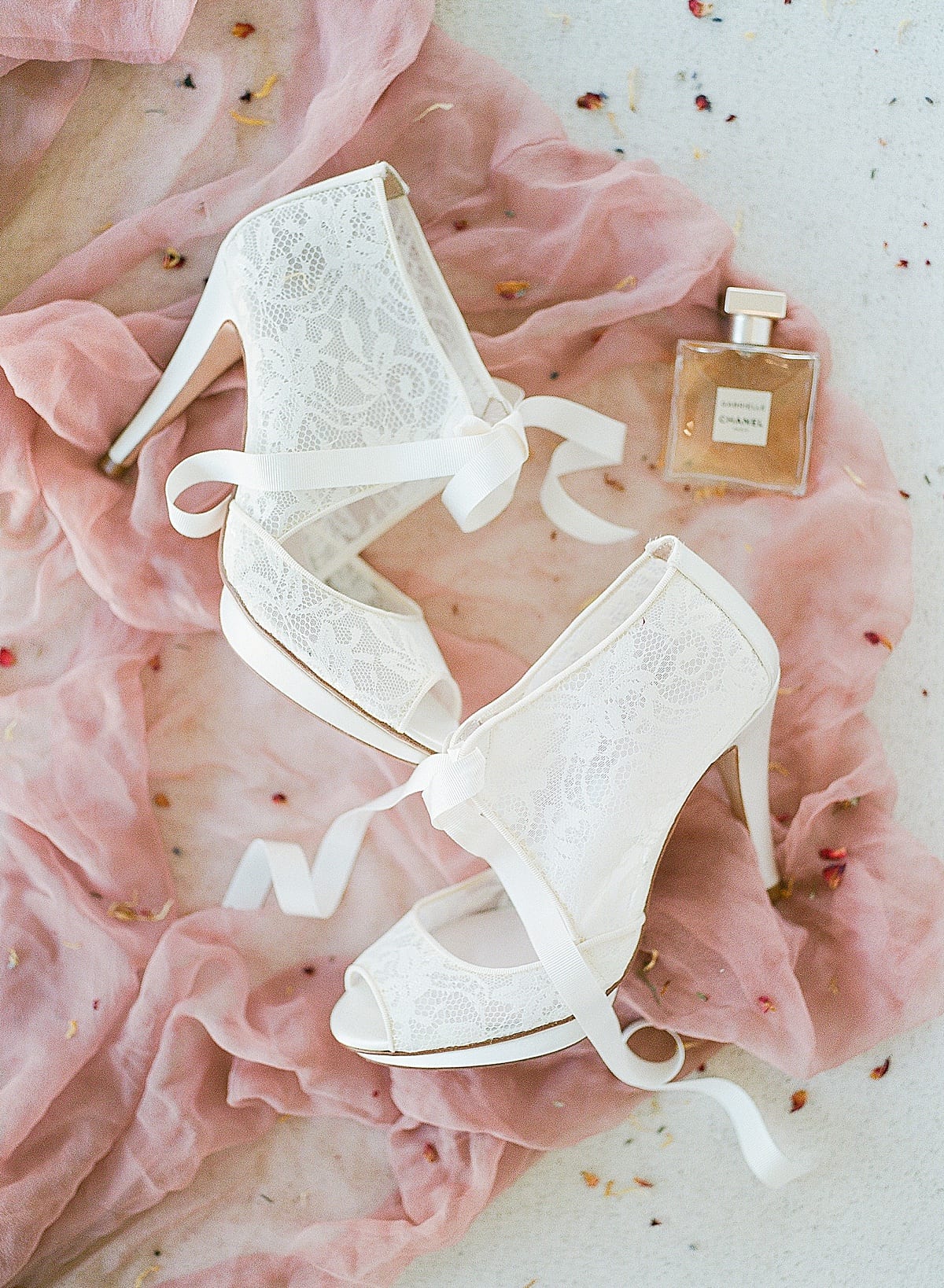Bridal Details Shoes and Perfume on Pink Fabric