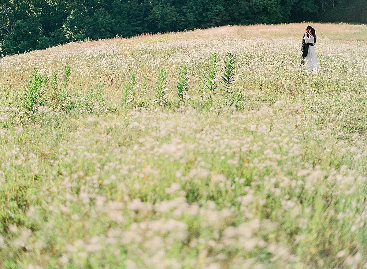 Bride and Groom in Field at bloomsbury farm photo