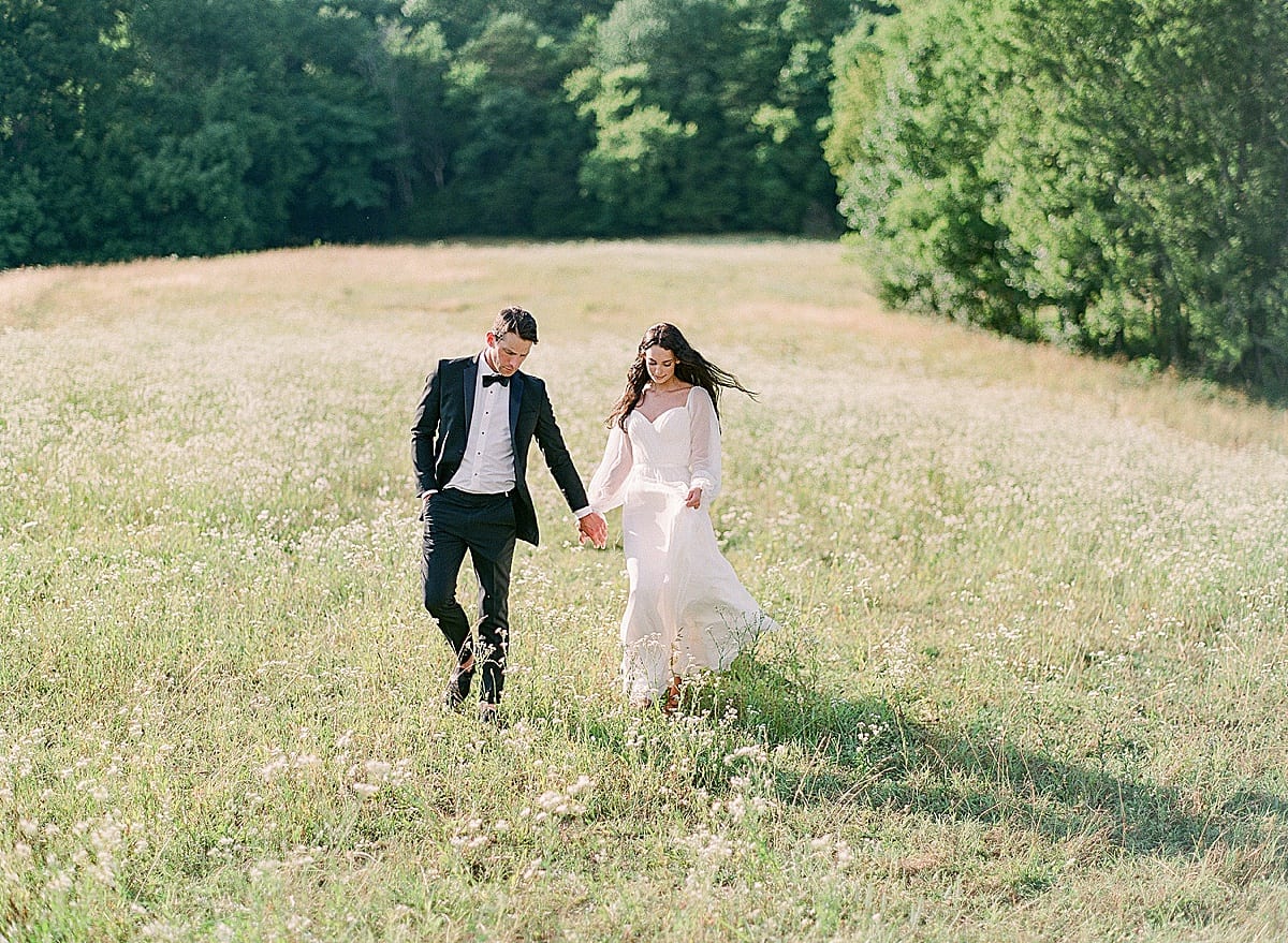 Bloomsbury Farm Wedding Venue In Nashville Bride and Groom Walking through Field Photo 