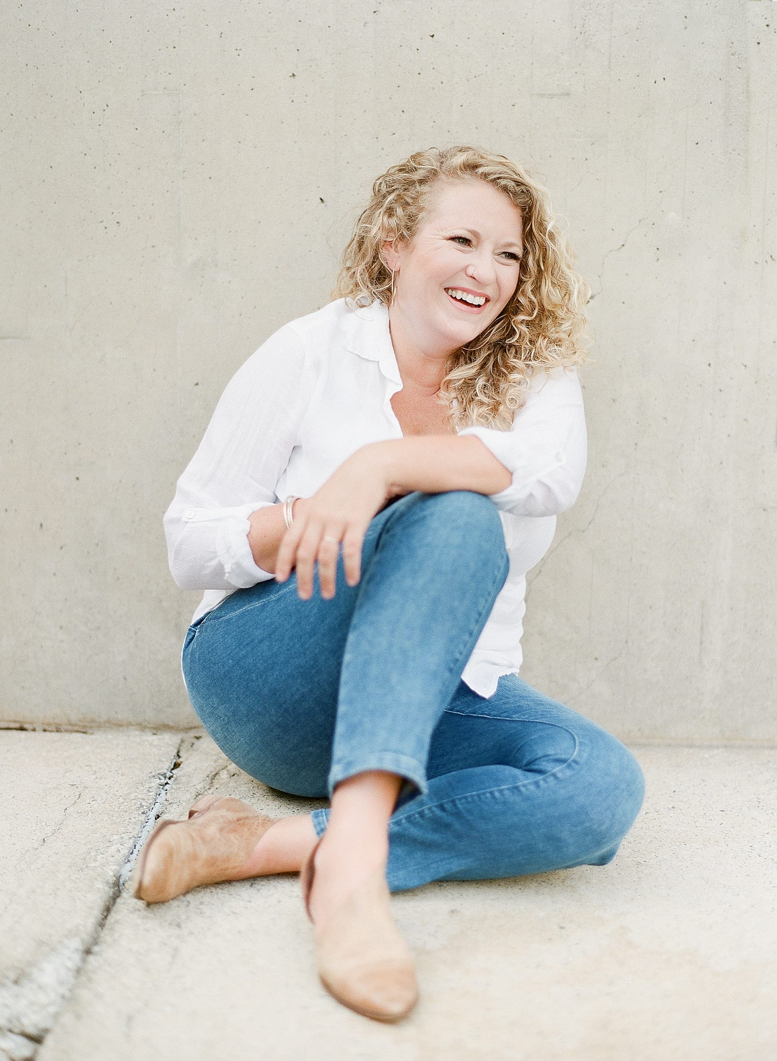 Branding Photography Woman Leaning on Wall Laughing Photo