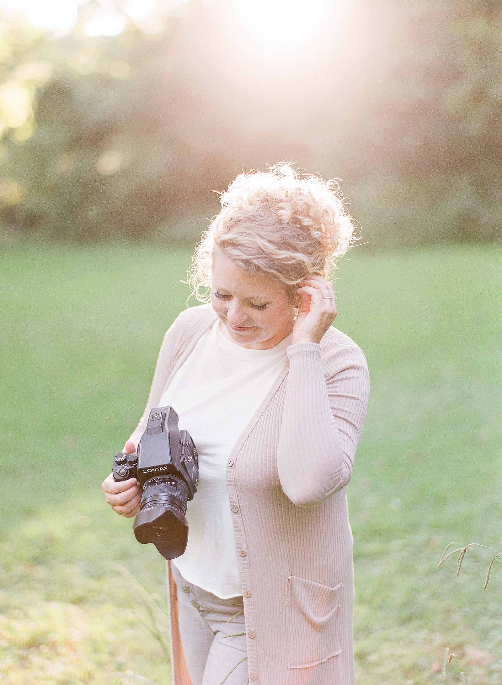Branding Photography Woman Holding Camera Looking Down Photo