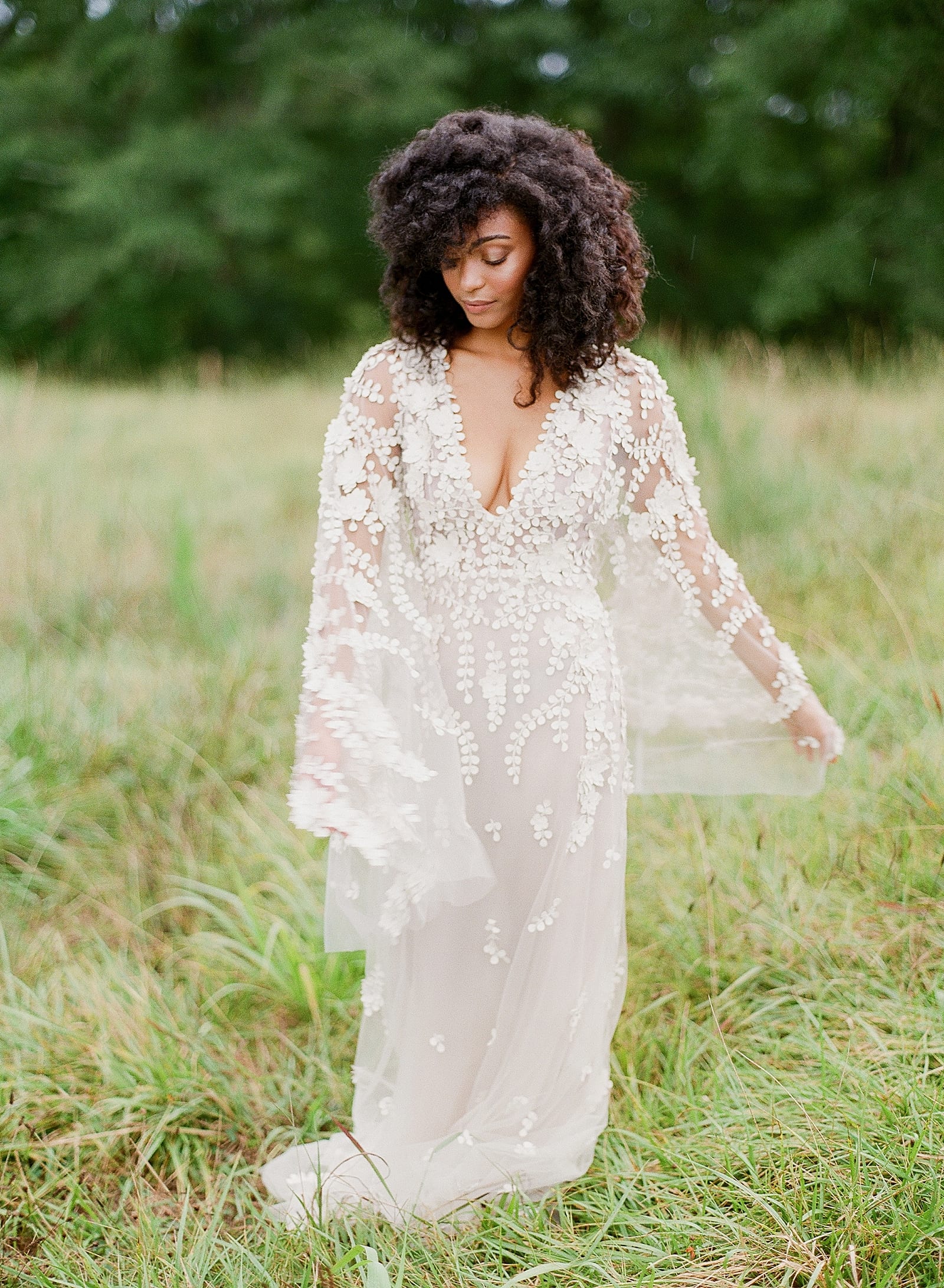 Bride in Dana Harel Design Gown twirling in field Photo