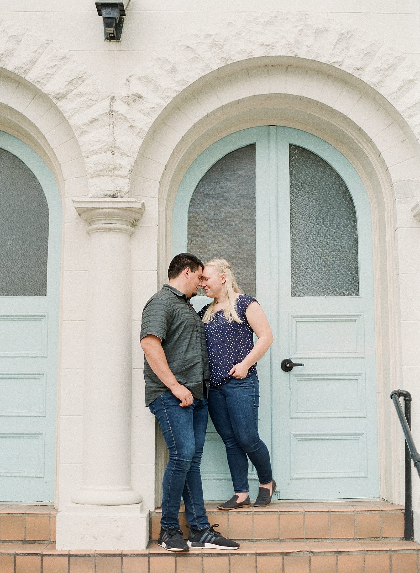 Downtown Raleigh NC Engagement Session Couple Snuggling on Stairs Photo