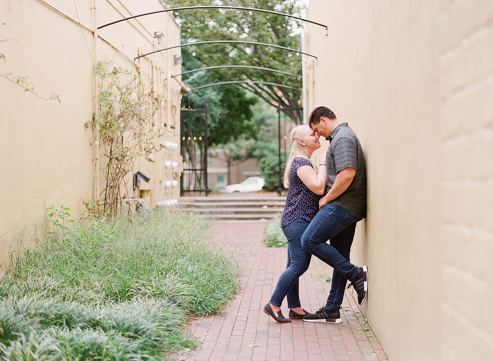 Downtown Raleigh NC Engagement Session Couple Leaning On Wall Photo