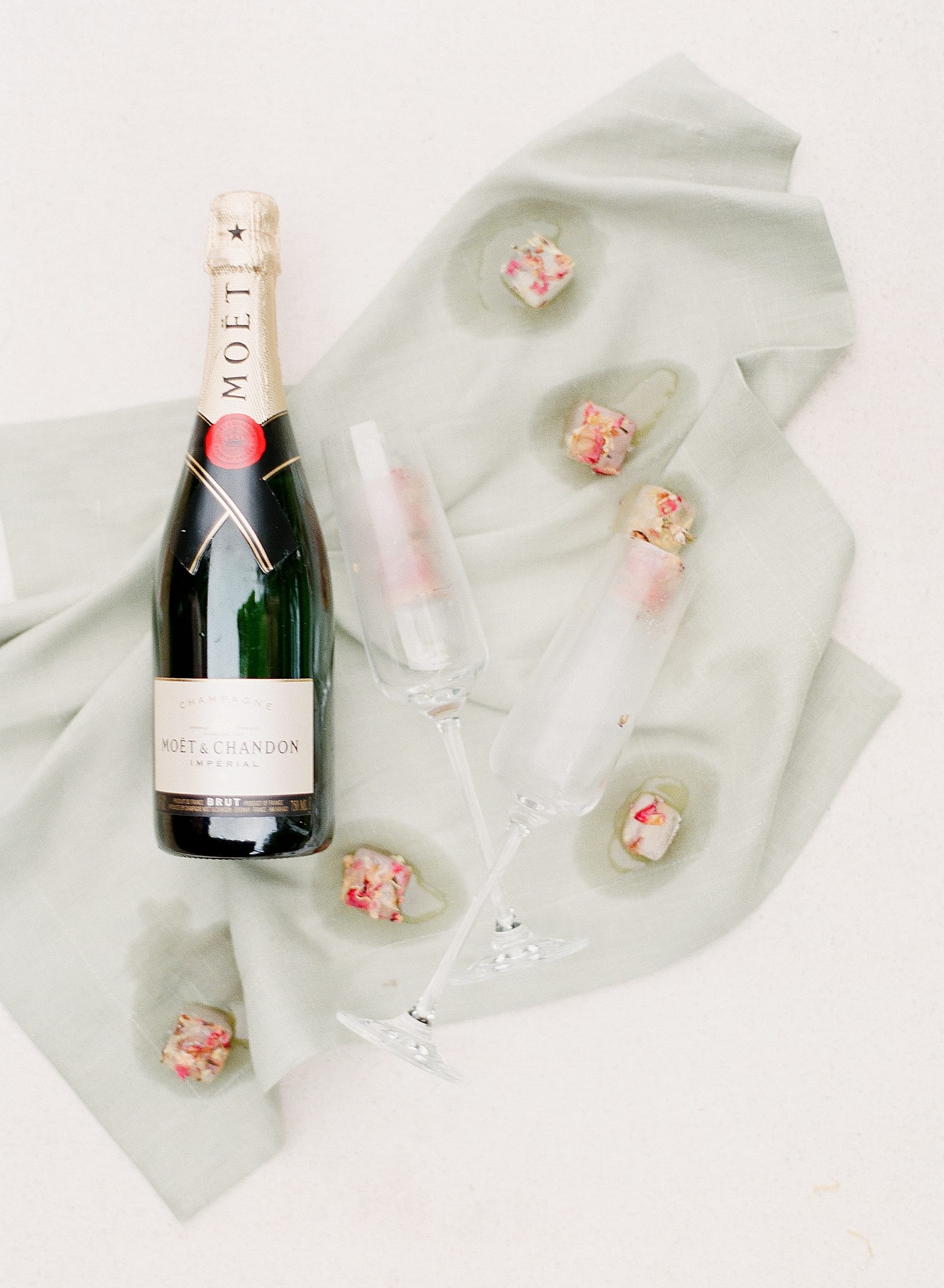 Champagne Bottle with Glasses and Melted Ice Cubes Photo