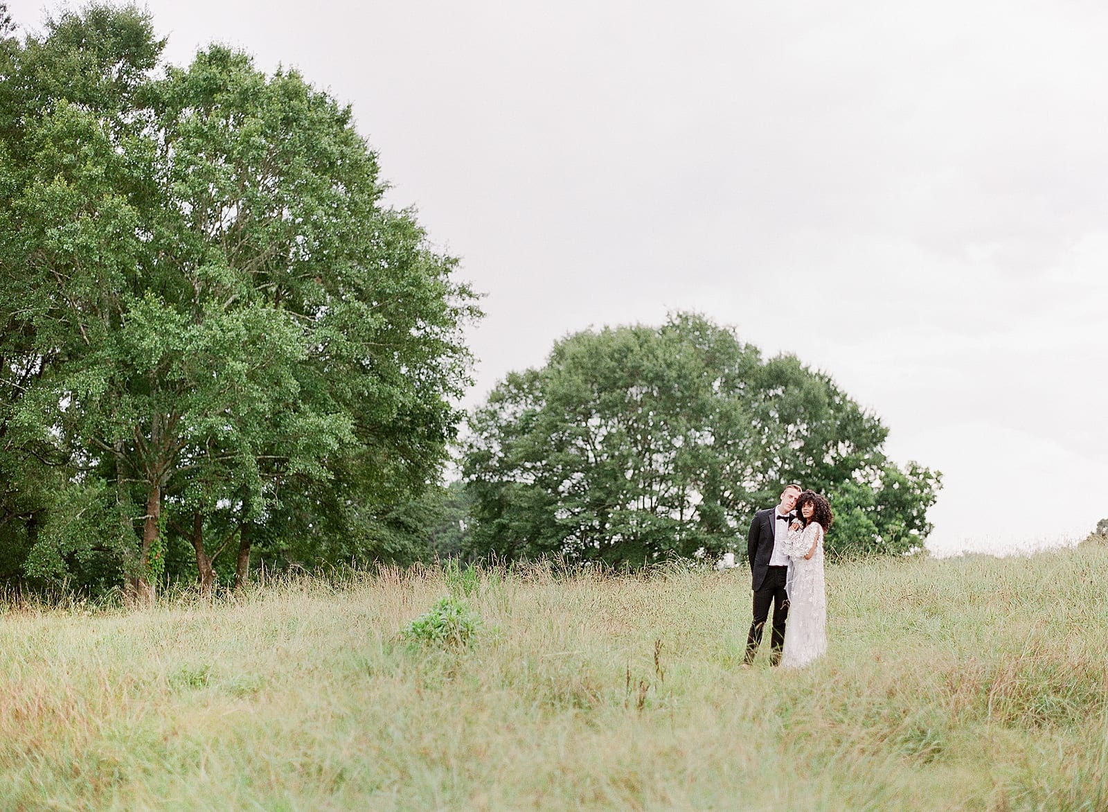 Bride and Groom in field at Inn at Serenbe Photo