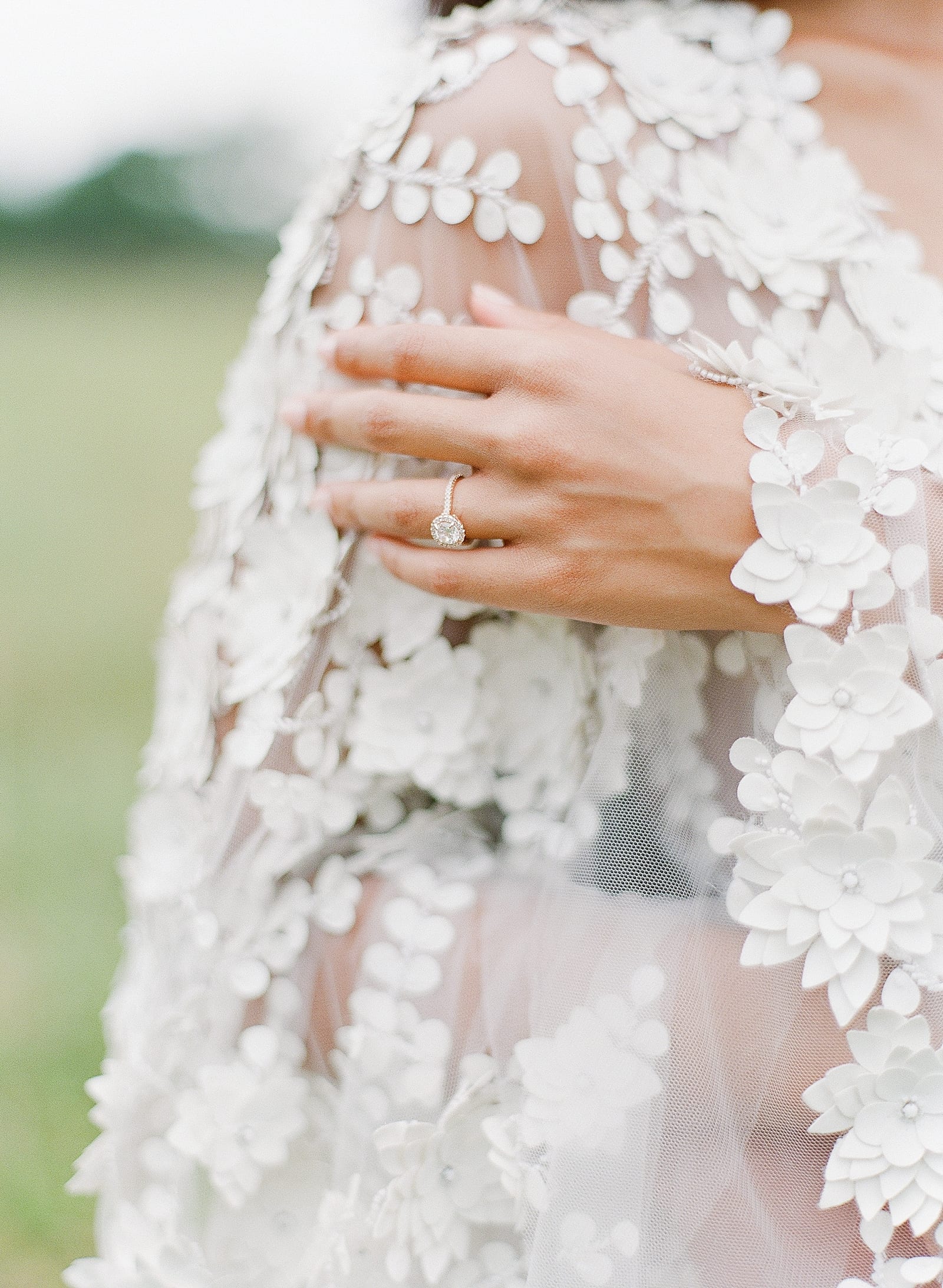 Brides Ring Hand on Gown Photo
