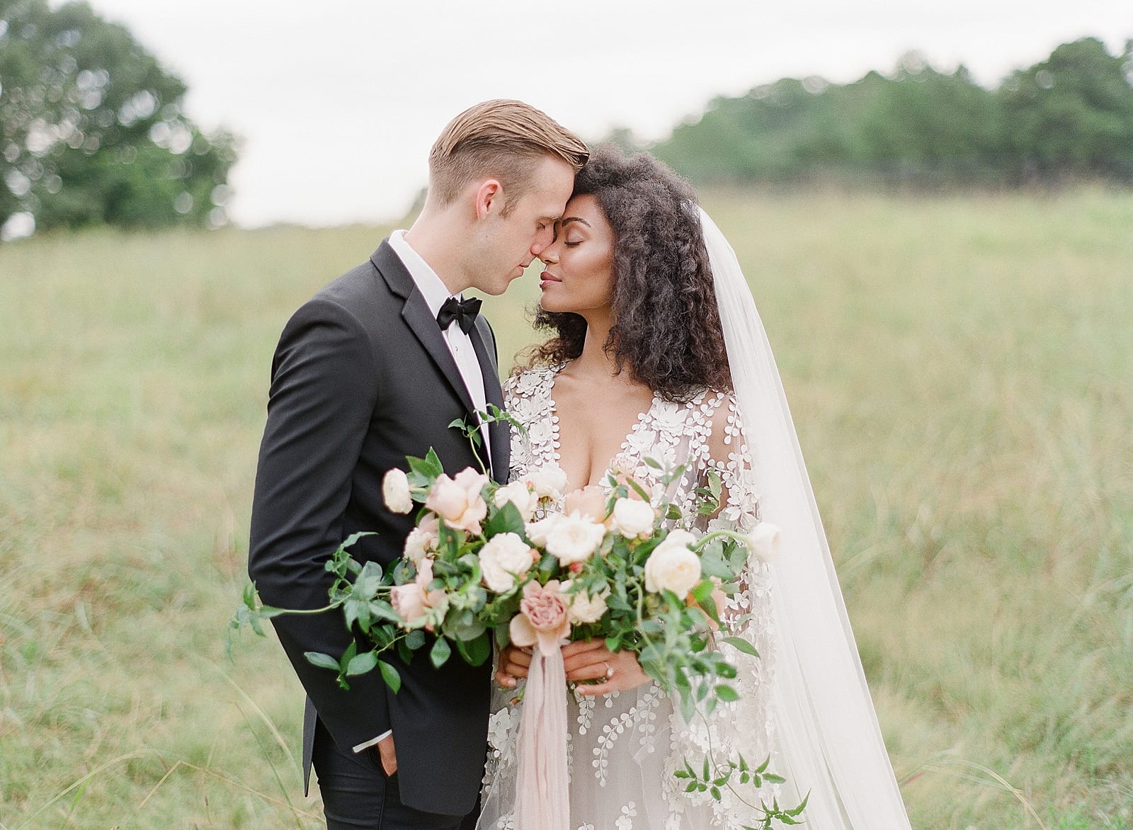 Bride and Groom Nose to Nose in Field at Inn at Serenbe