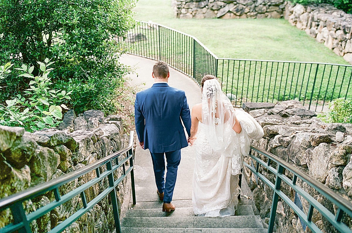Omni Grove Park Inn Bride and Groom Walking Down Stairs Holding Hands Photo
