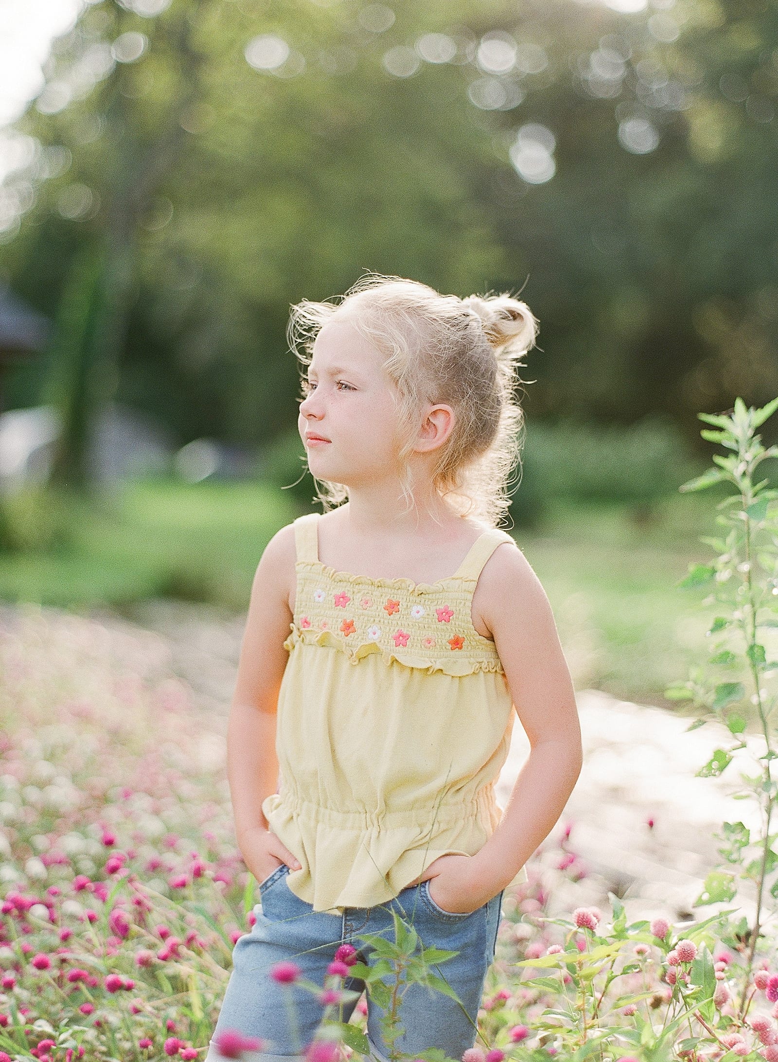 Little Girl in Flowers Looking Off Photo