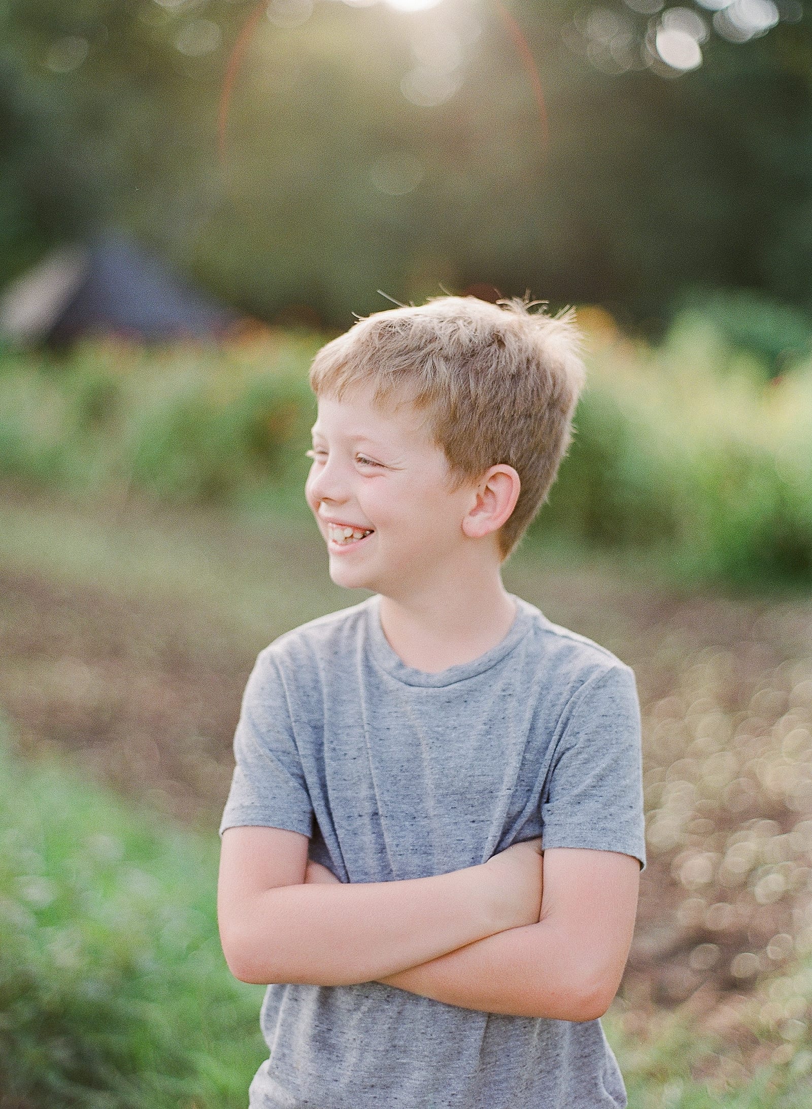 Little Boy with Arms Crossed Laughing Photo
