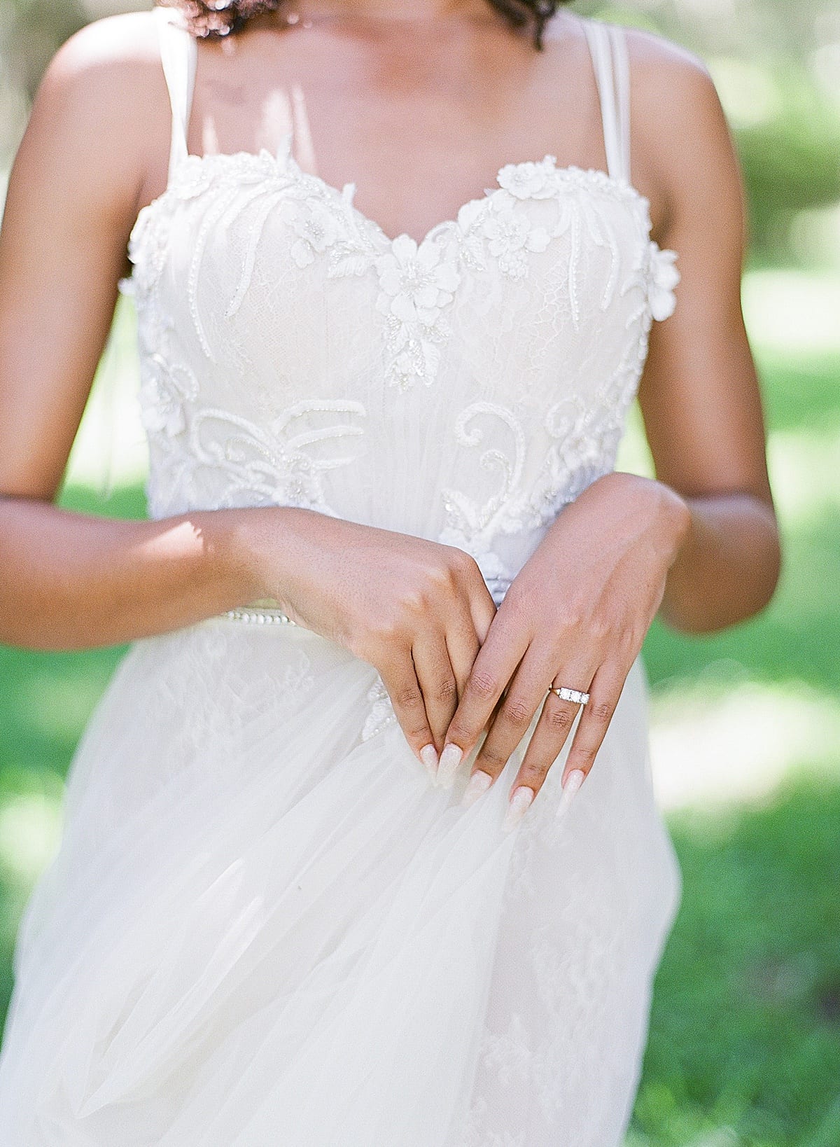 Detail of Brides Bodice with Bride holding Tulle of Dress Photo 