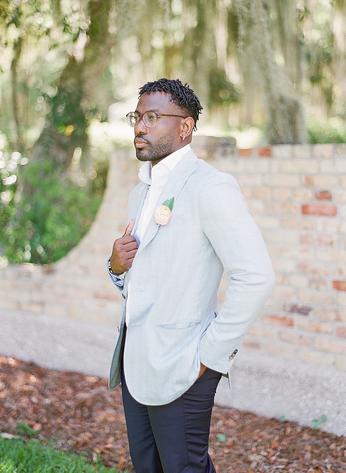 Groom Holding a Light Blue Suit Jacket Looking Off Photo 