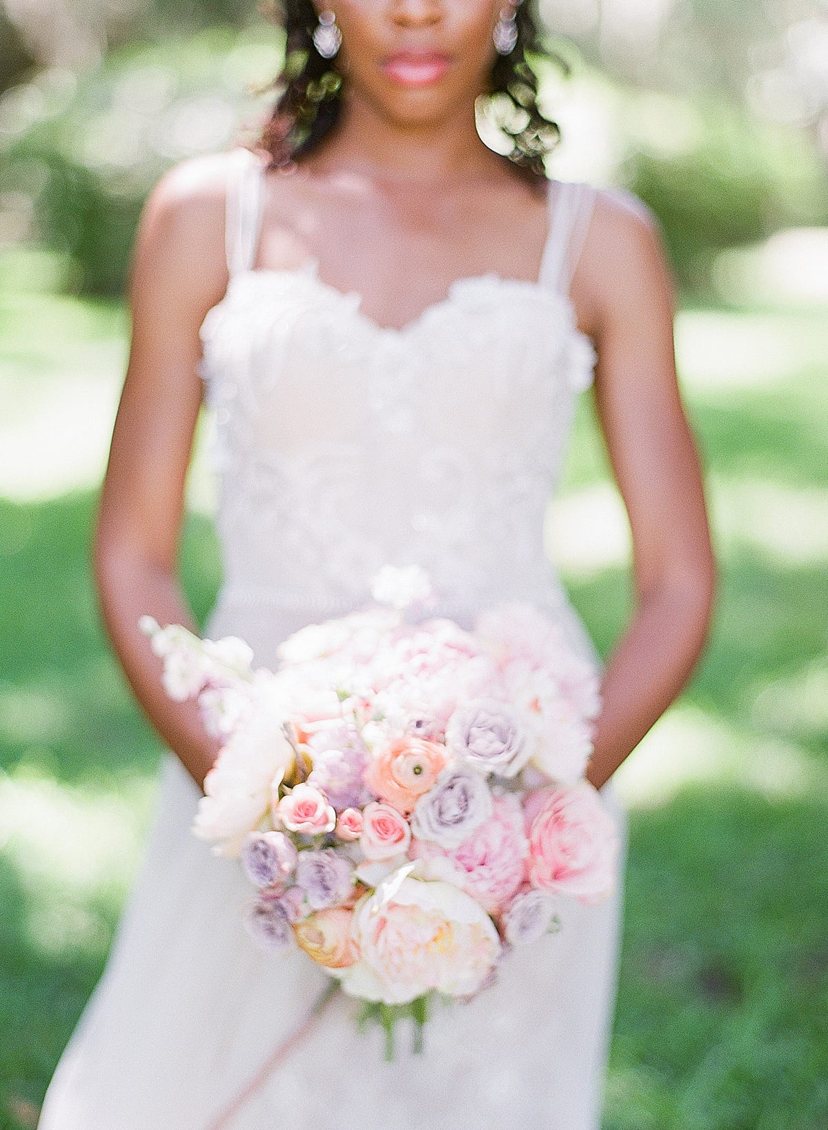 Bride Holding Bouquet of Pastel Flowers Photo 