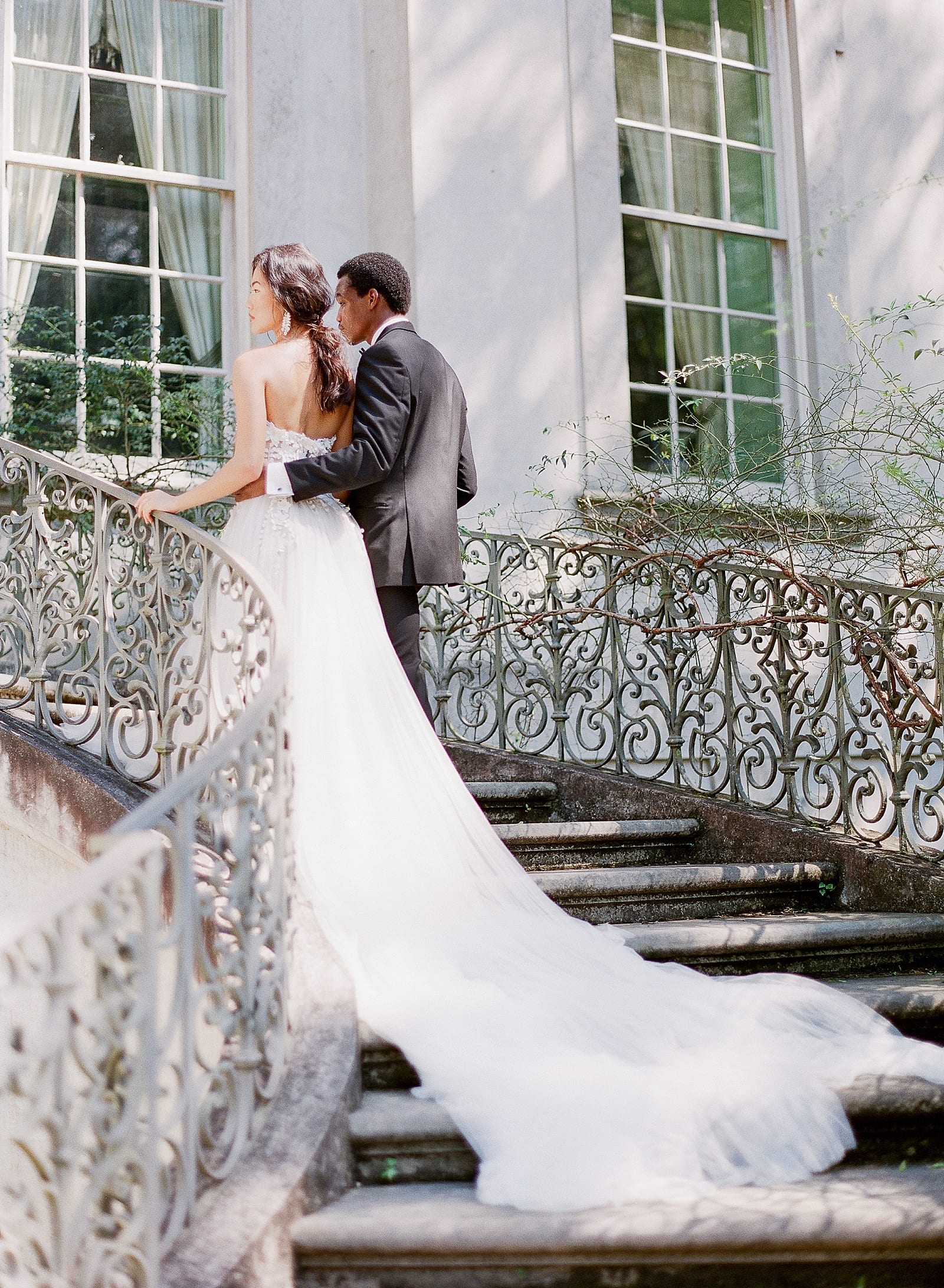 Bride and Groom Walking up Back Stairs of The Swan House In Atlanta Photo