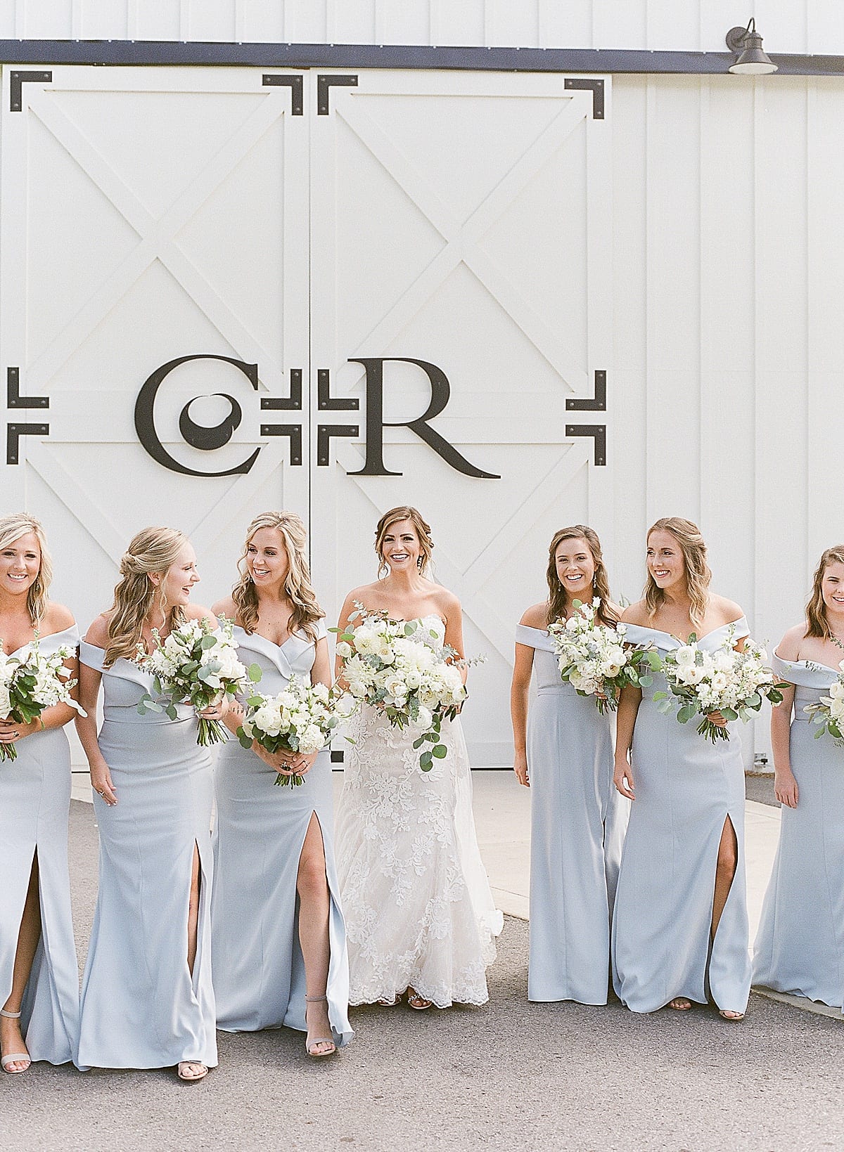 Bride Walking With Bridesmaids in Blue Dresses Photo
