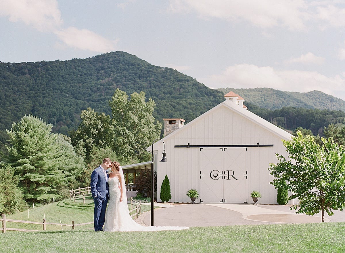 Chestnut Ridge Bride and Groom Nose to Nose in Front of Venue Photo