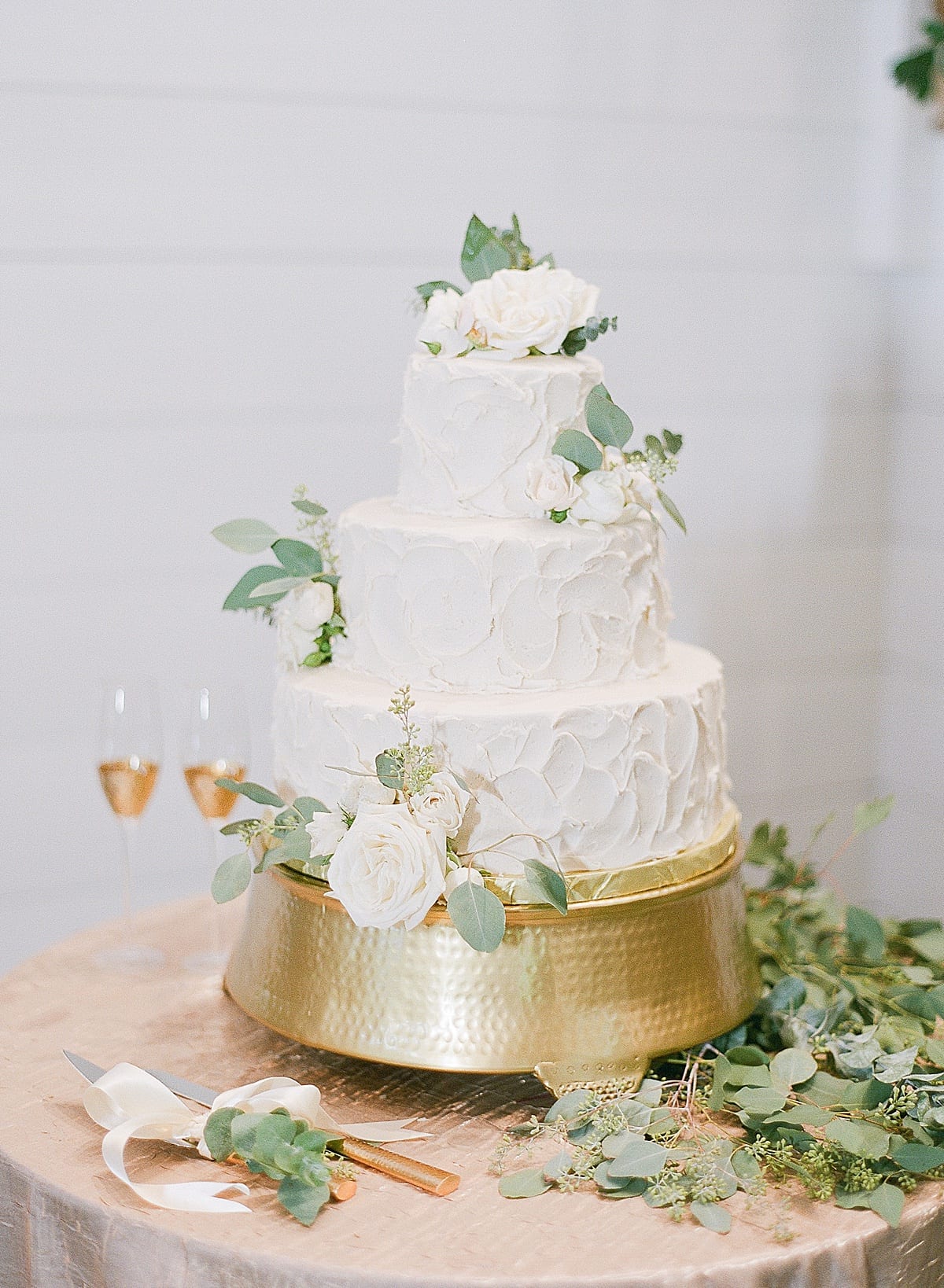 White Wedding Cake with White Flowers on Gold Cake Stand Photo