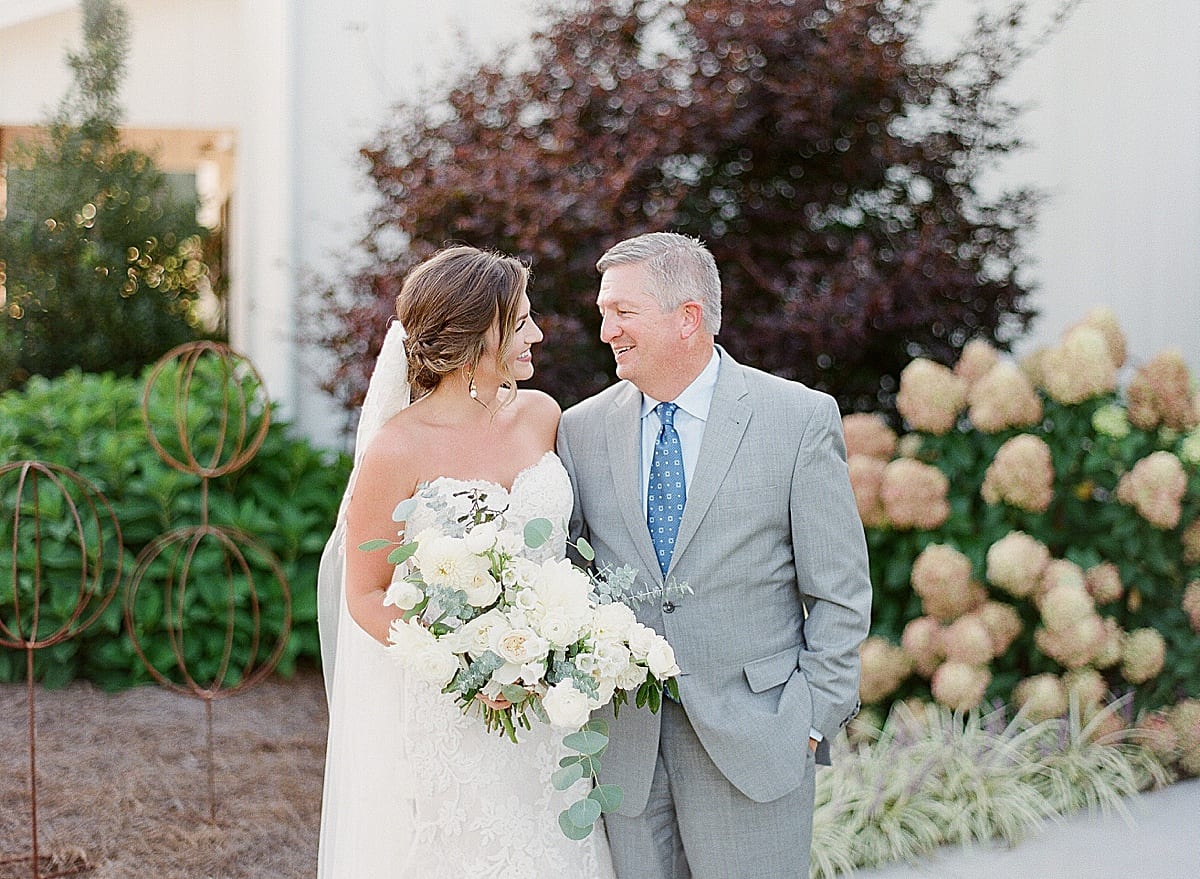 Bride with Her Dad Smiling at Each Other Photo