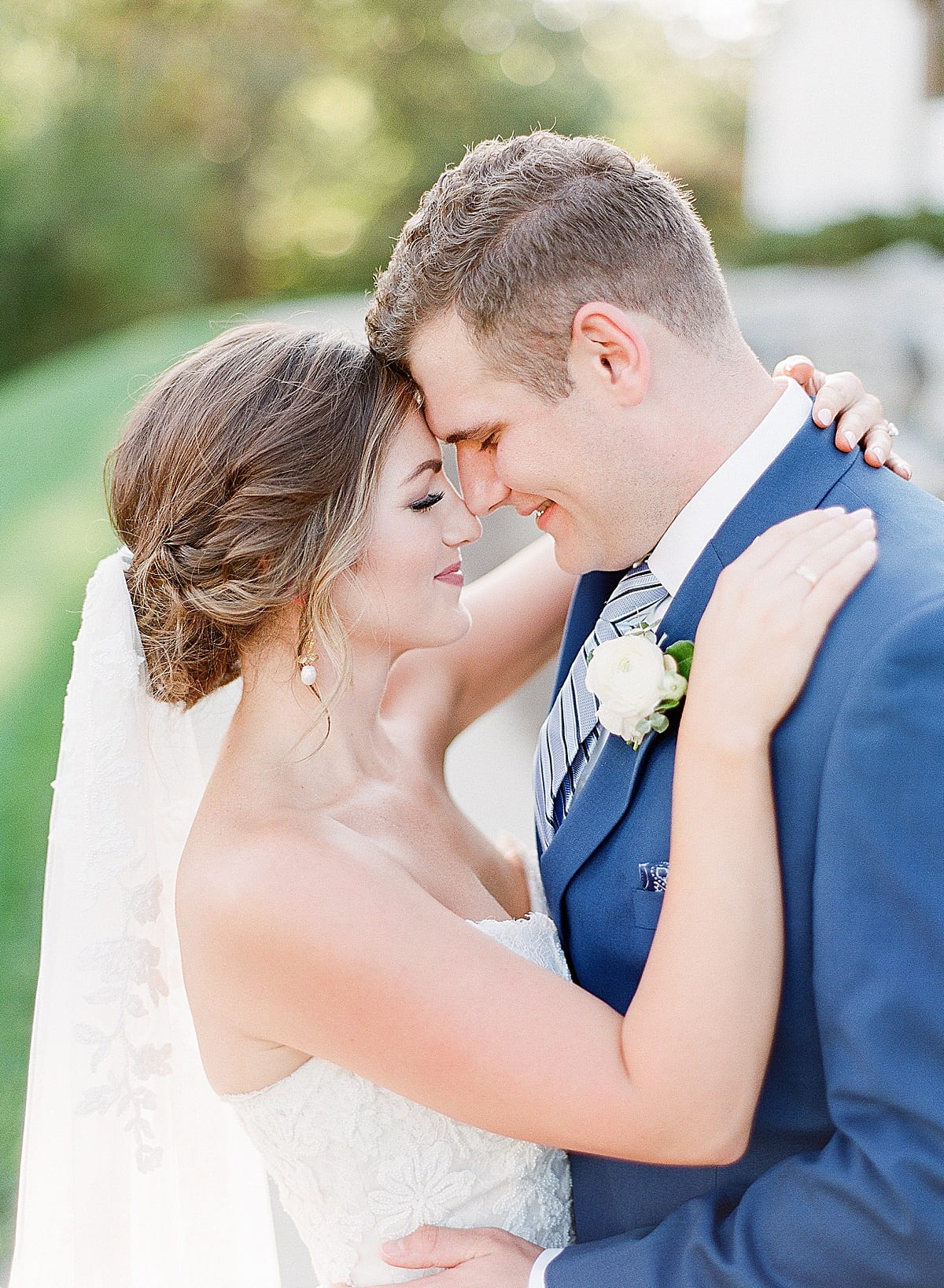Bride and Groom Hugging Nose to Nose Photo