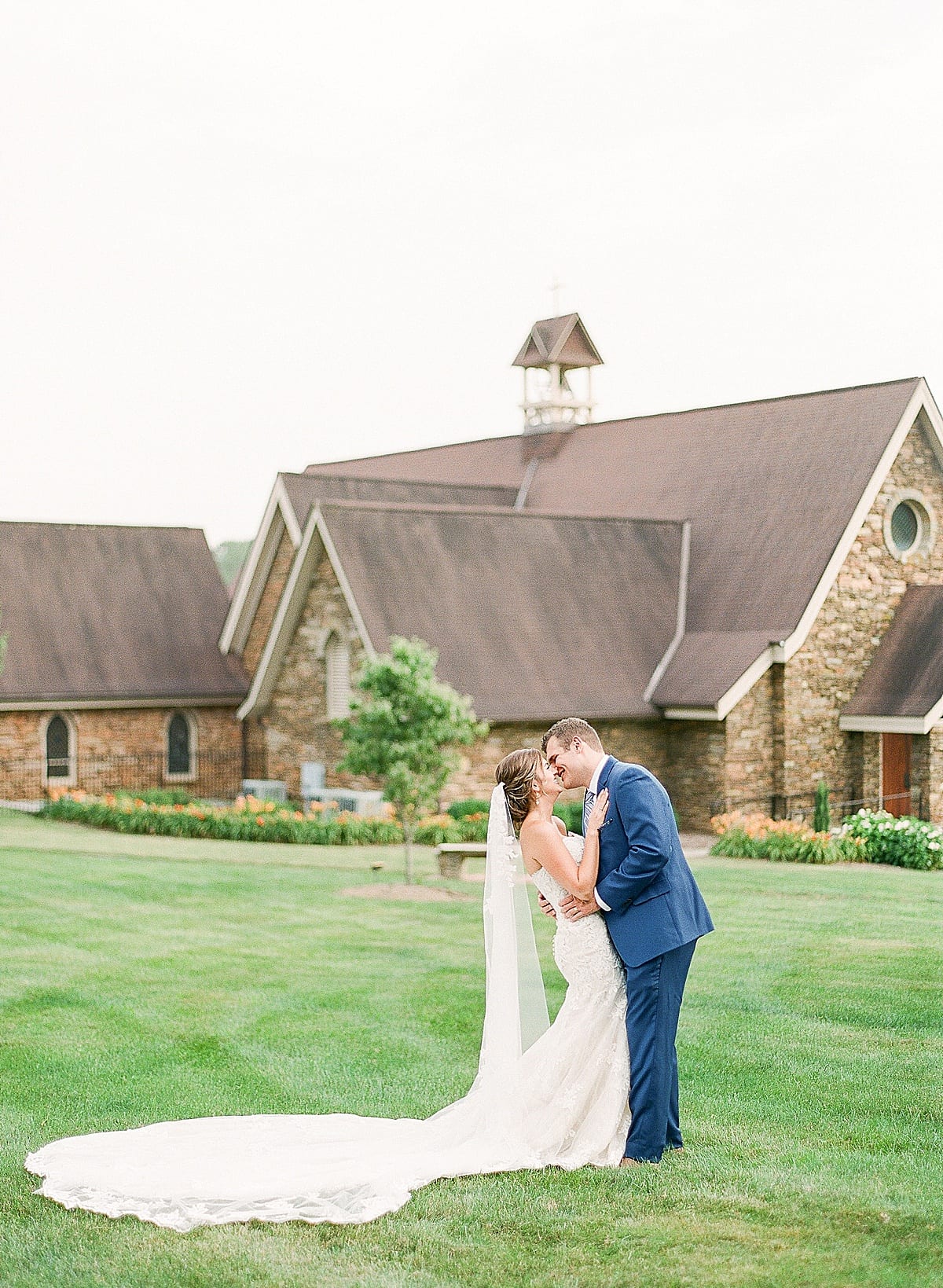 Christ School’s Chapel Asheville North Carolina Wedding Bride and Groom Kissing Photo
