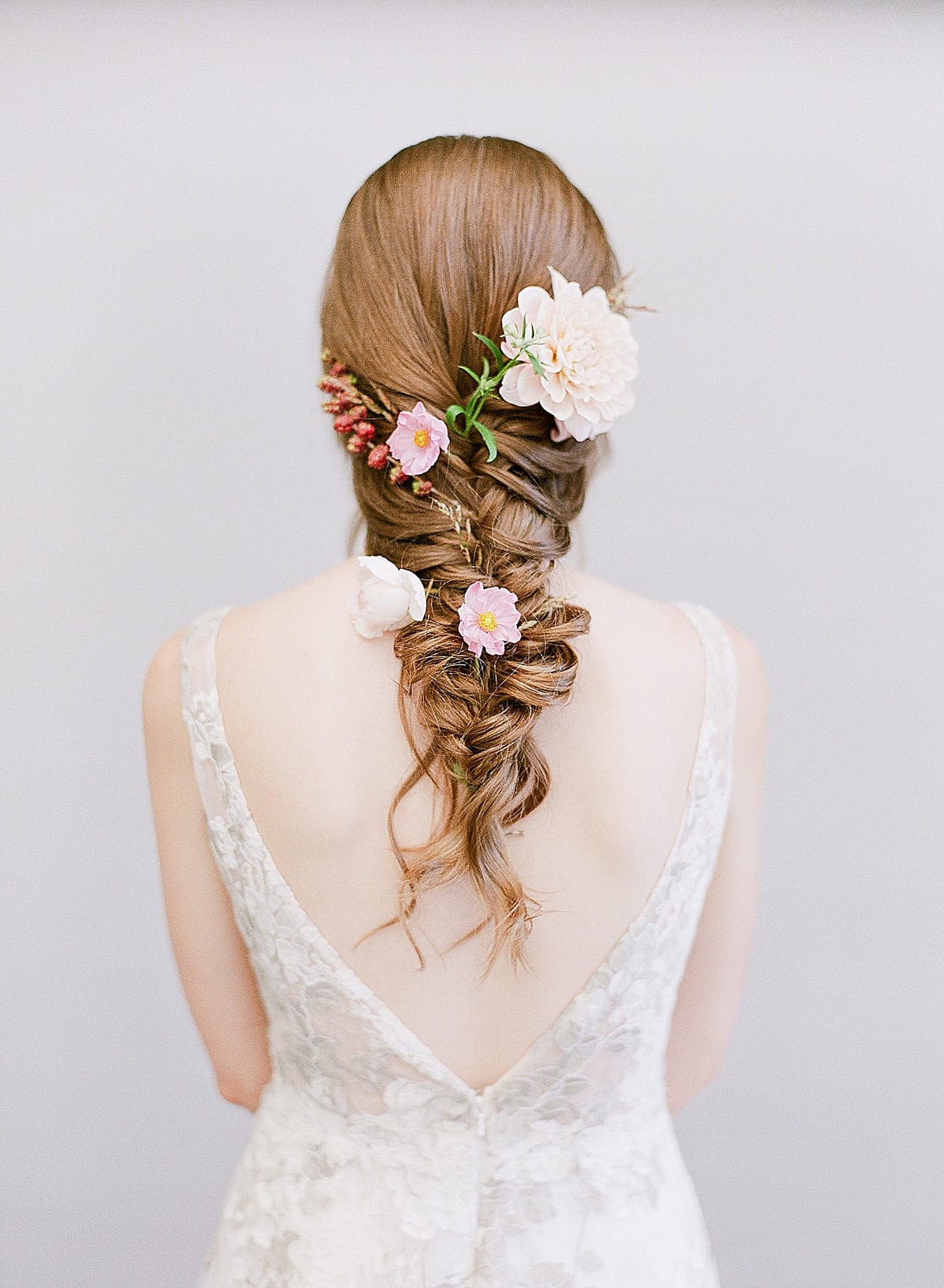 Bride in front of Gray Background with Flowers in Braided Hair Photo