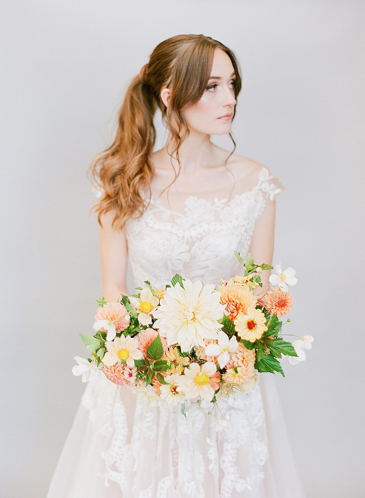 Wedding Hair and Makeup Bride Holding Bouquet with Ponytail Photo