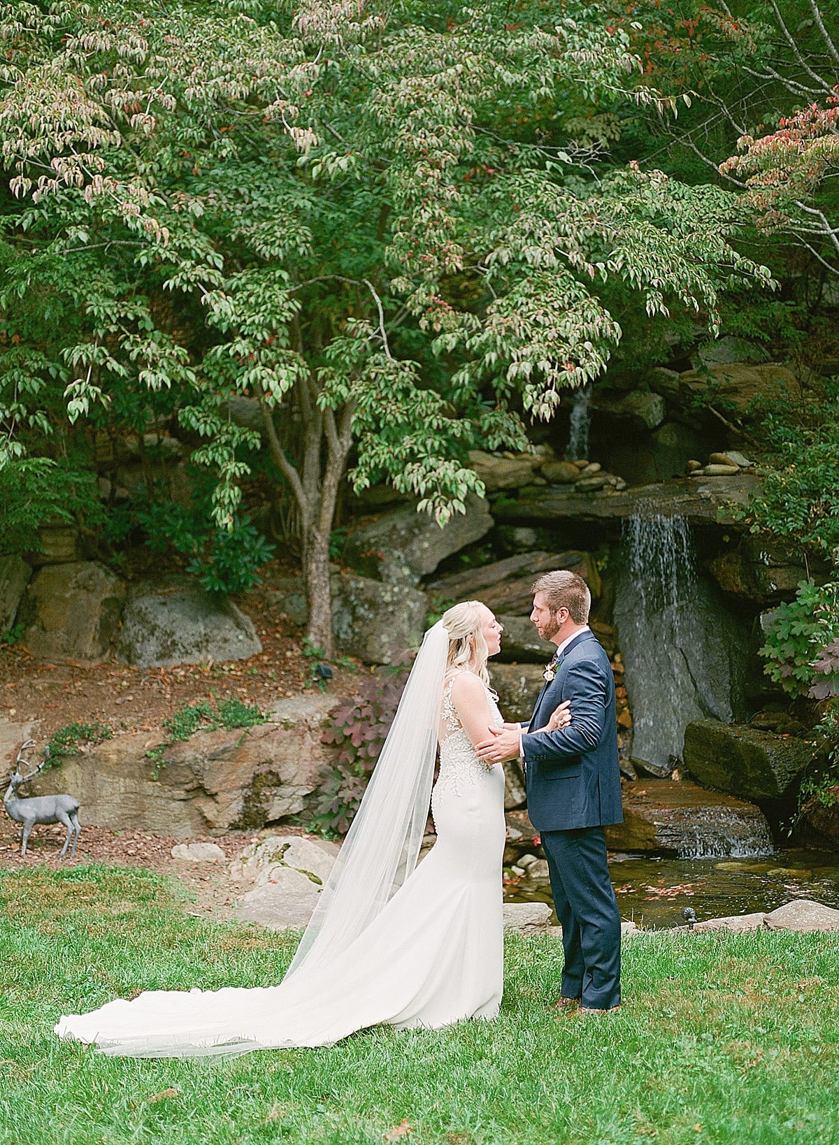 Bride and Grooms First Look in Front of Mini Waterfall Photo