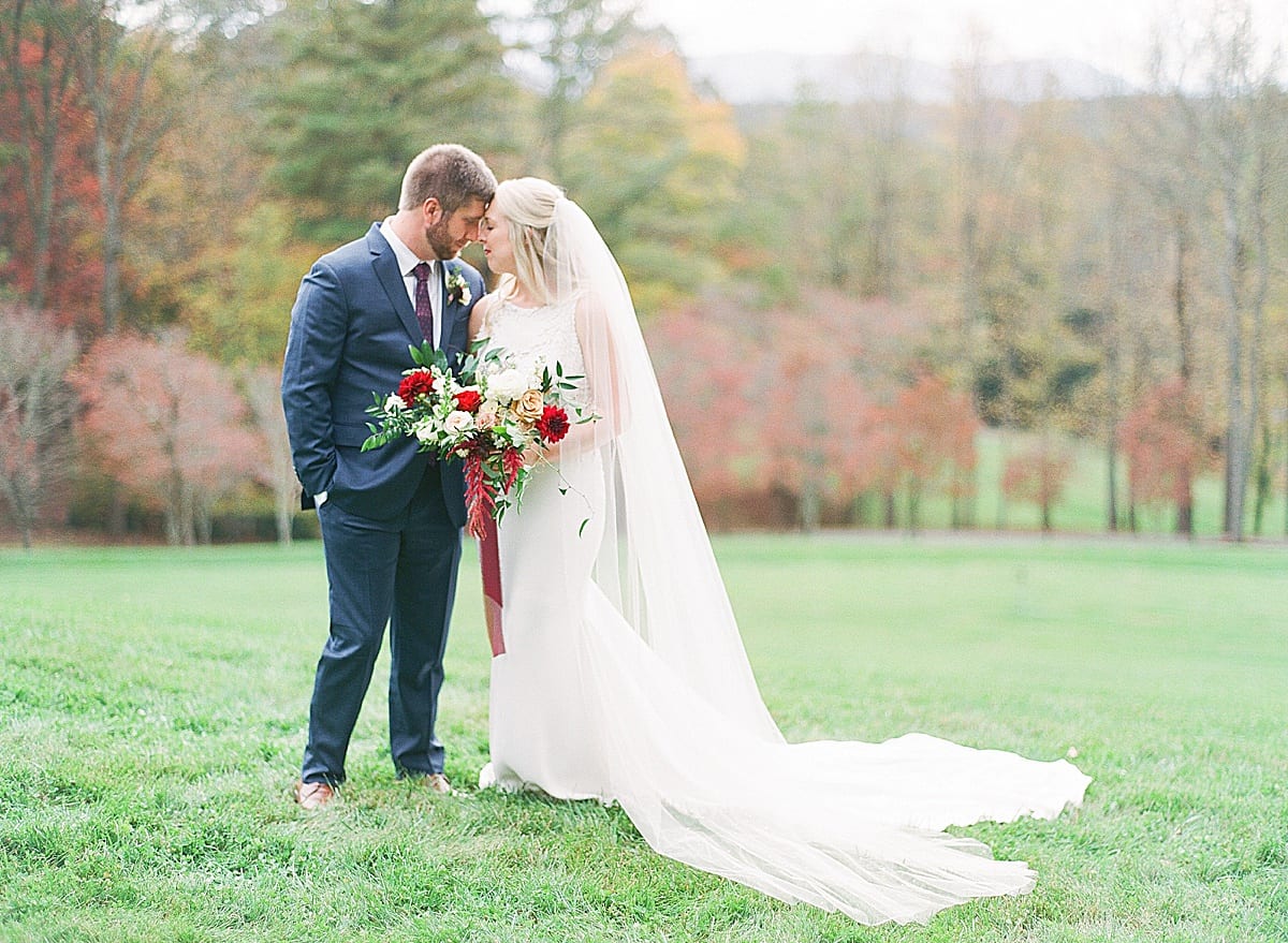 Bride and Groom Nose to Nose in Field Photo