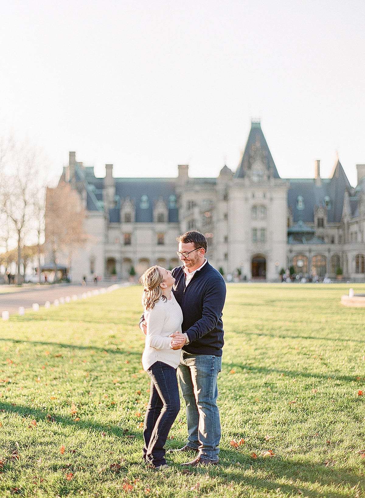 Couple Holding Hands Smiling on Front Lawn of Biltmore Estate Photo
