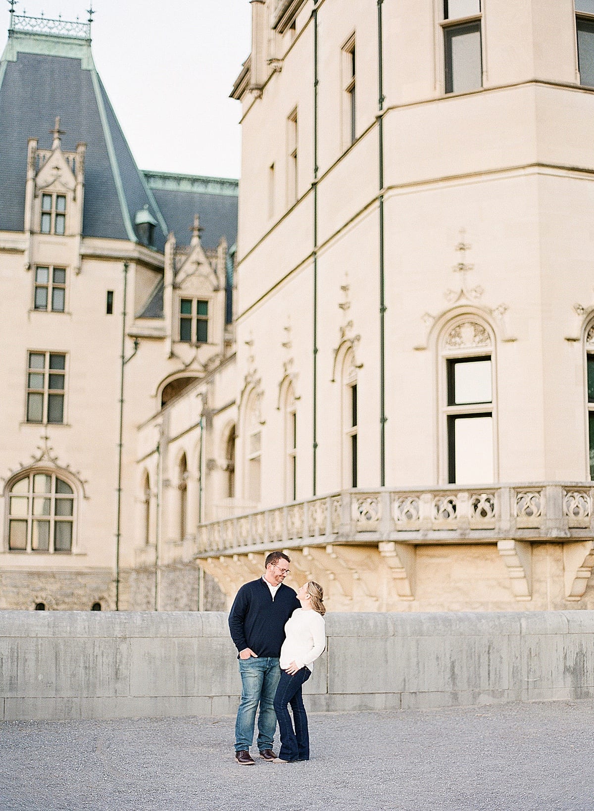 Couple Smiling at Each Other in Front of Biltmore Estate Photo