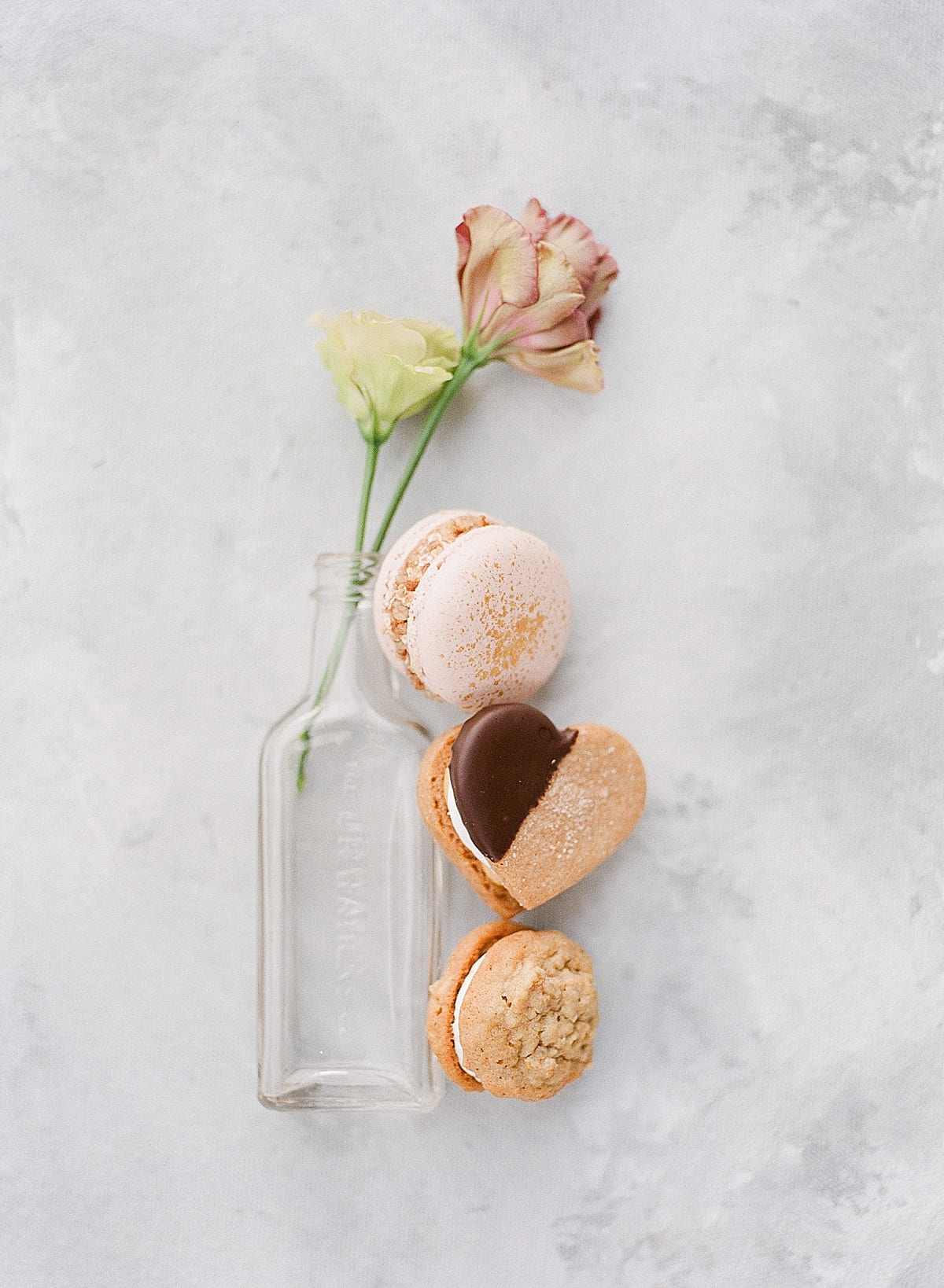 Detail of Glass Bottle with Flower and Cookies Photo