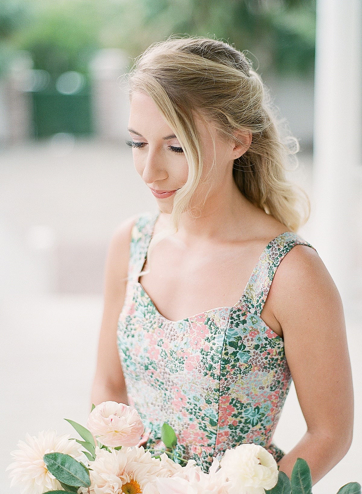 Woman Looking Down Holding Flowers Photo