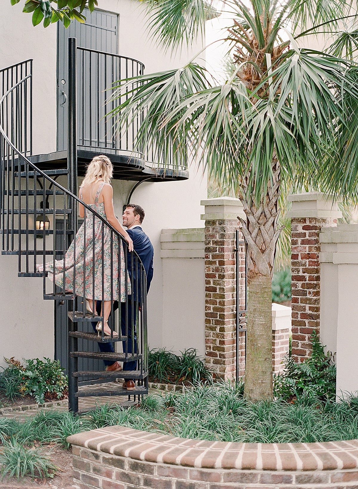 Couple Walking Down Spiral Staircase at Charleston SC Wedding Venue Gadsden House Photo