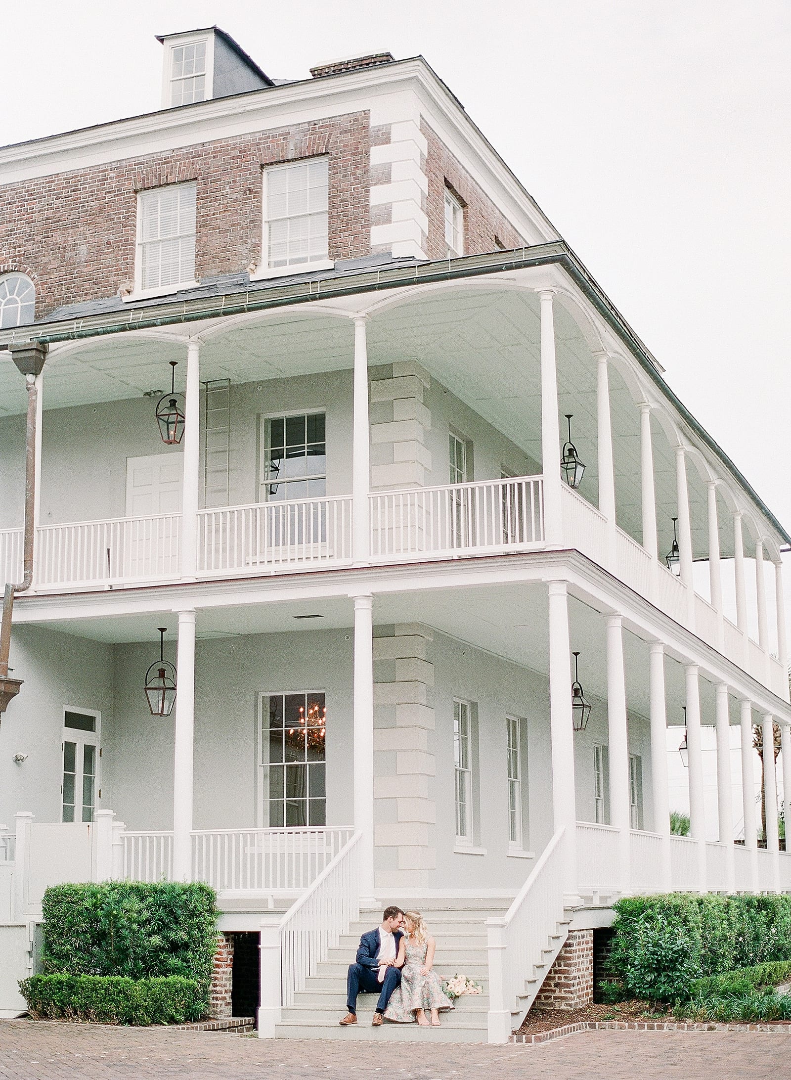 Couple Sitting on Steps of Gadsden House Photo