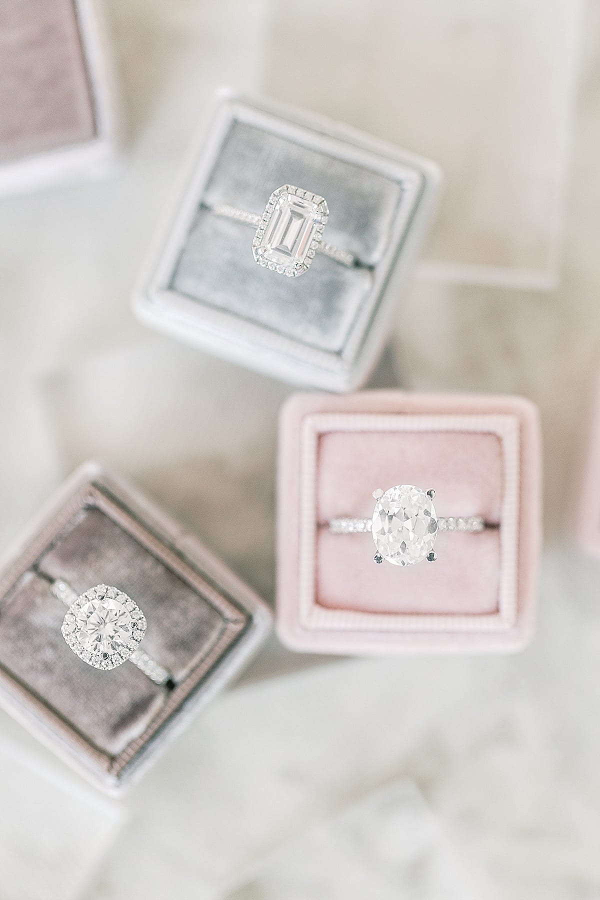 Set of Three Diamond Engagement Rings in Ring Boxes Photo