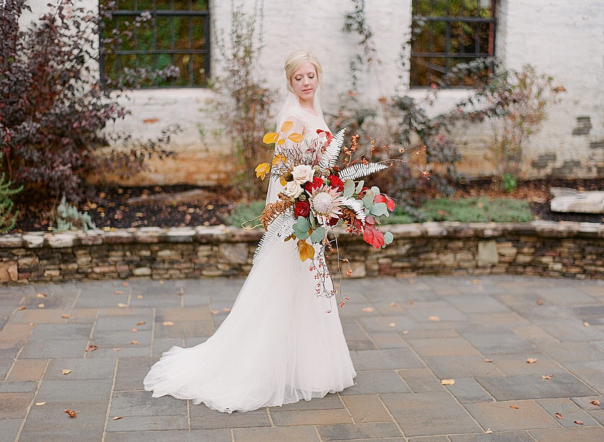 Fall North Carolina Wedding Bride with Huge Bridal Bouquet Looking Down Photo