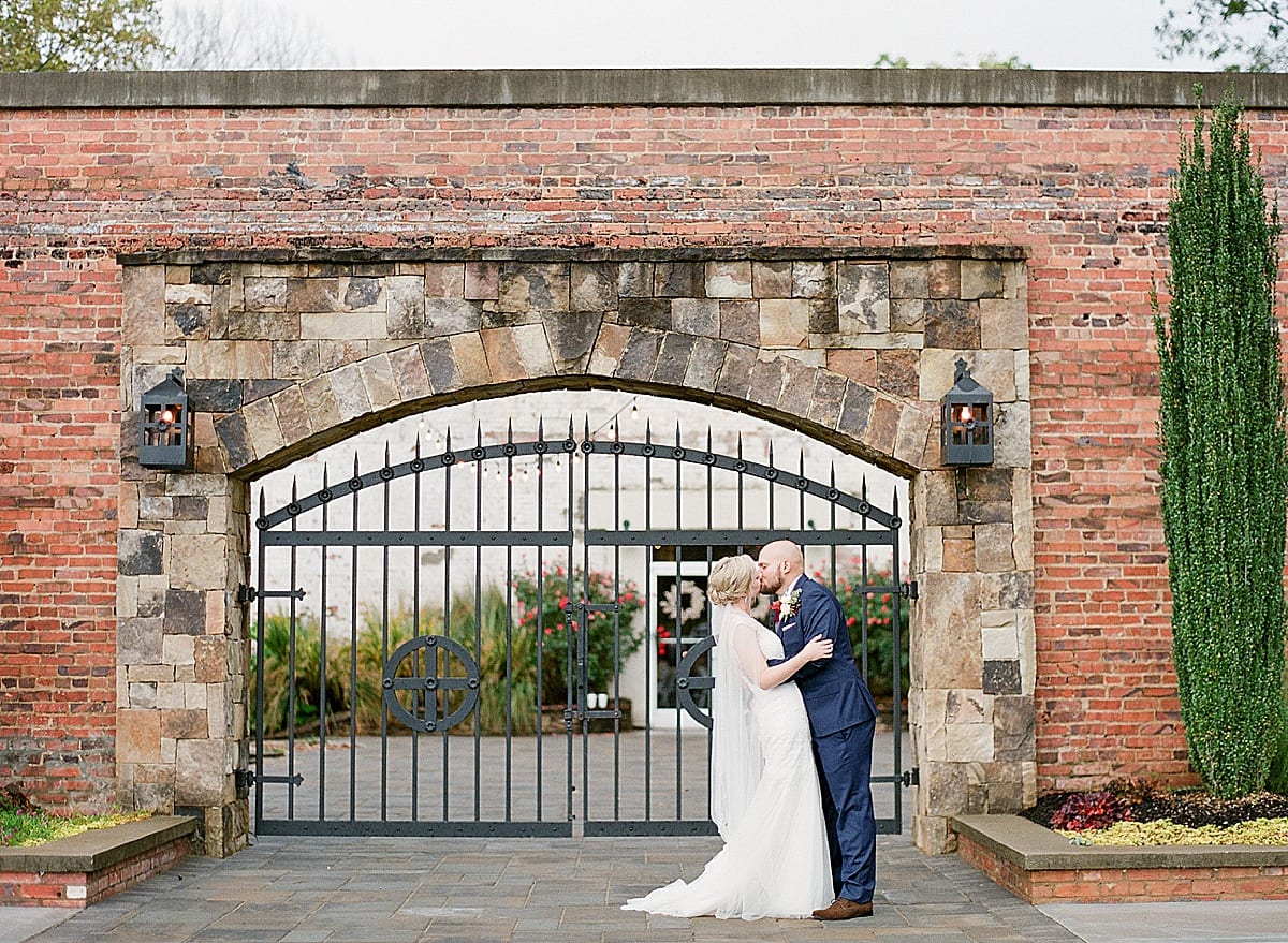 Couple in front of Iron gate Kissing Photo
