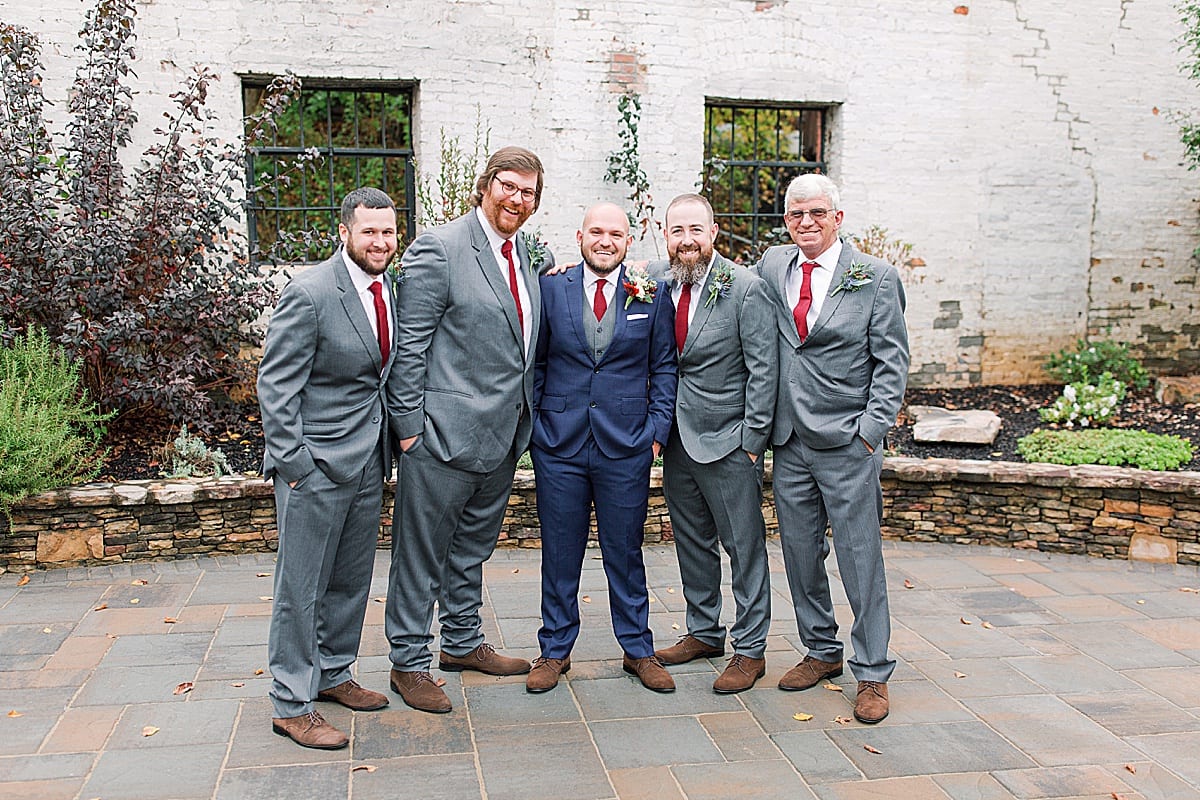 Groom with Groomsmen in Blue and Grey Suits Smiling at camera Photo