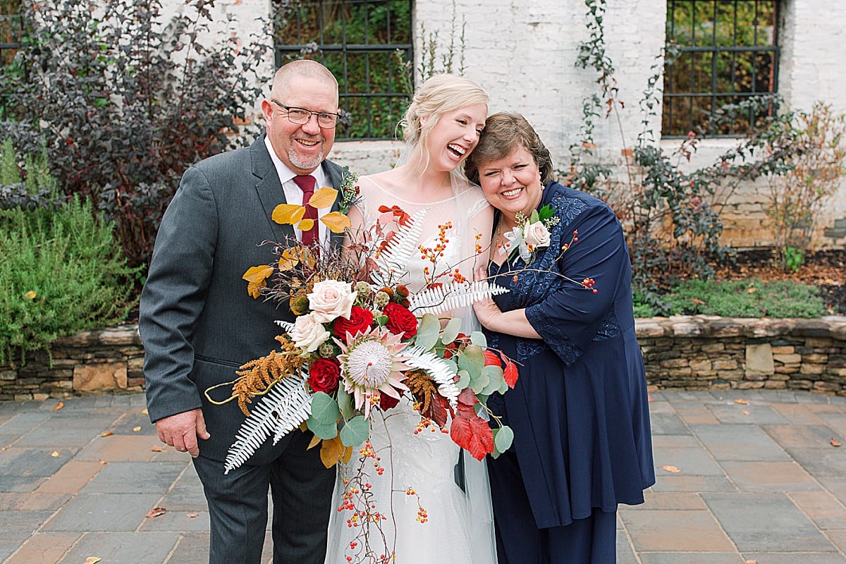 Bride Laughing and Hugging Parents Photo