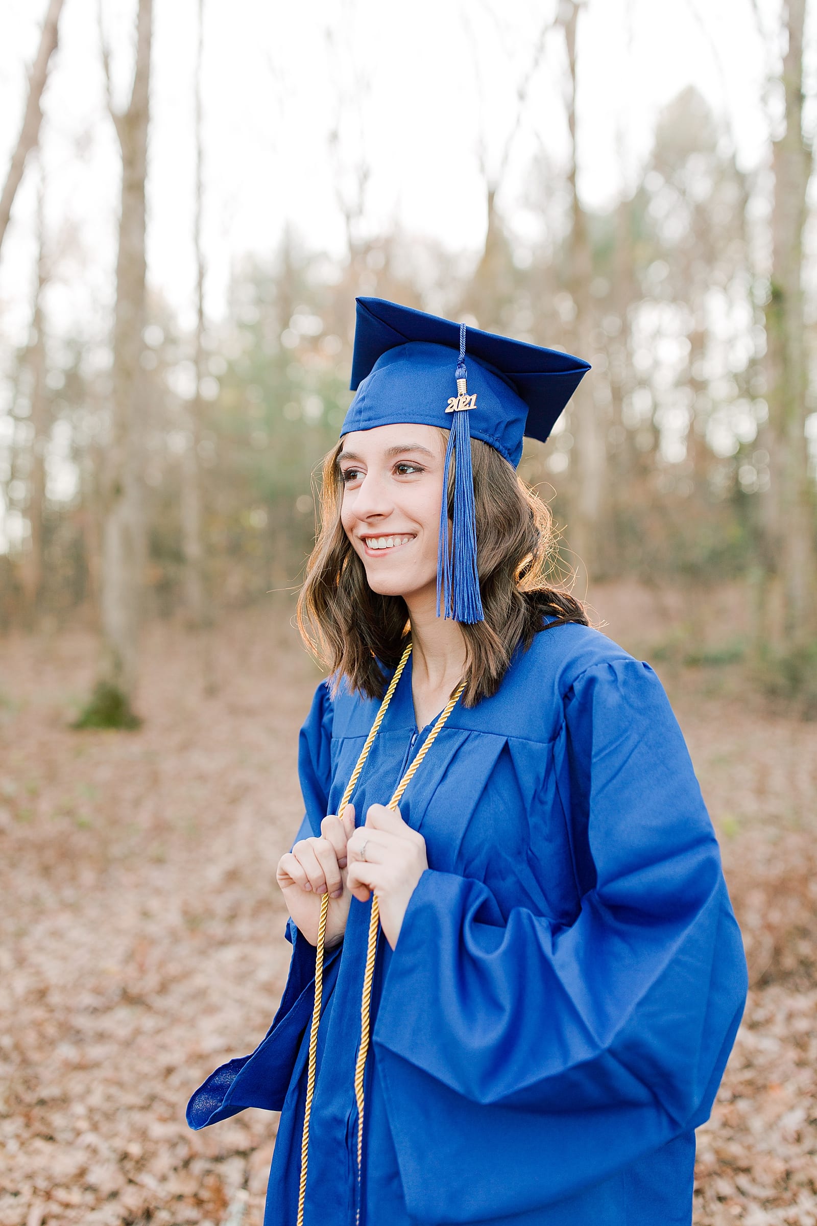High School Senior Pictures Senior in Blue Cap and Gown Photo