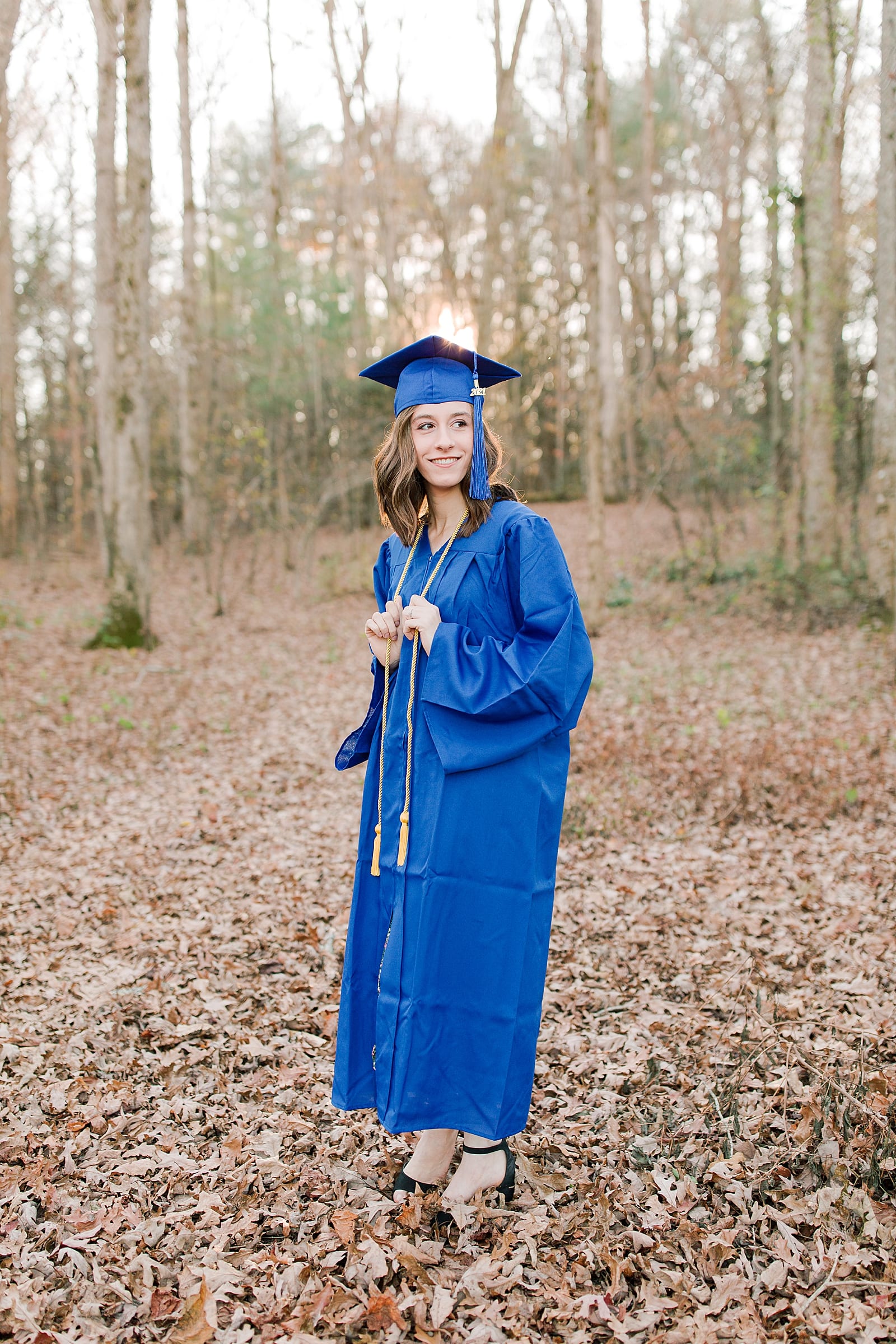 High School Senior Pictures Senior in Blue Cap and Gown Photo